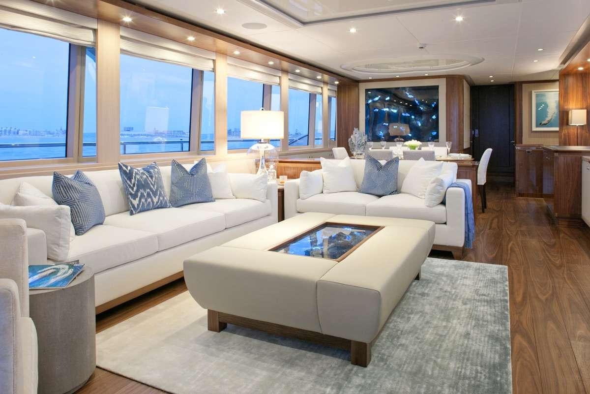 a living room with a couch and a table aboard FIREFLY Yacht for Charter