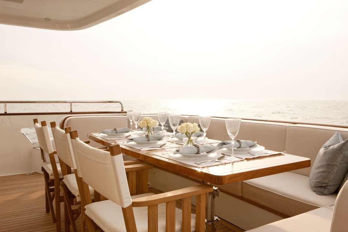 a table set for a dinner aboard FIREFLY Yacht for Charter