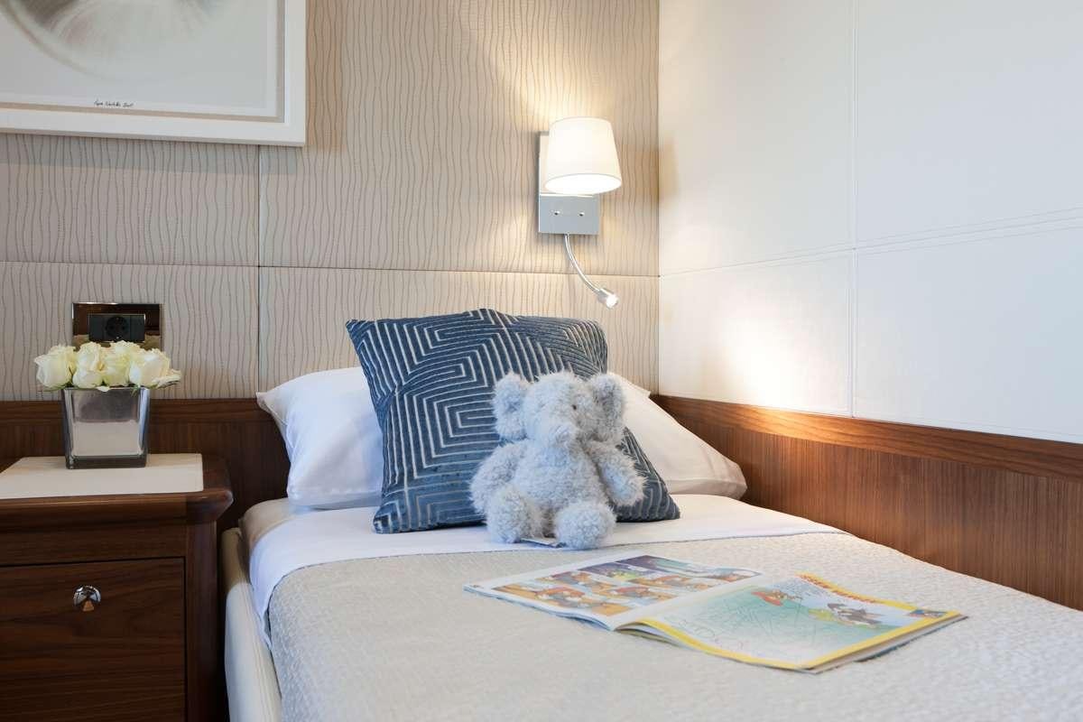 a teddy bear on a bed aboard FIREFLY Yacht for Charter
