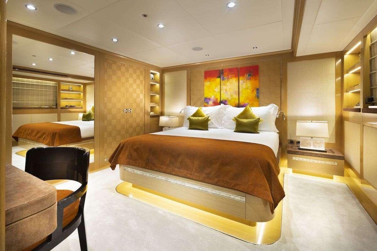 a room with a bed and a desk aboard AUDACES Yacht for Charter