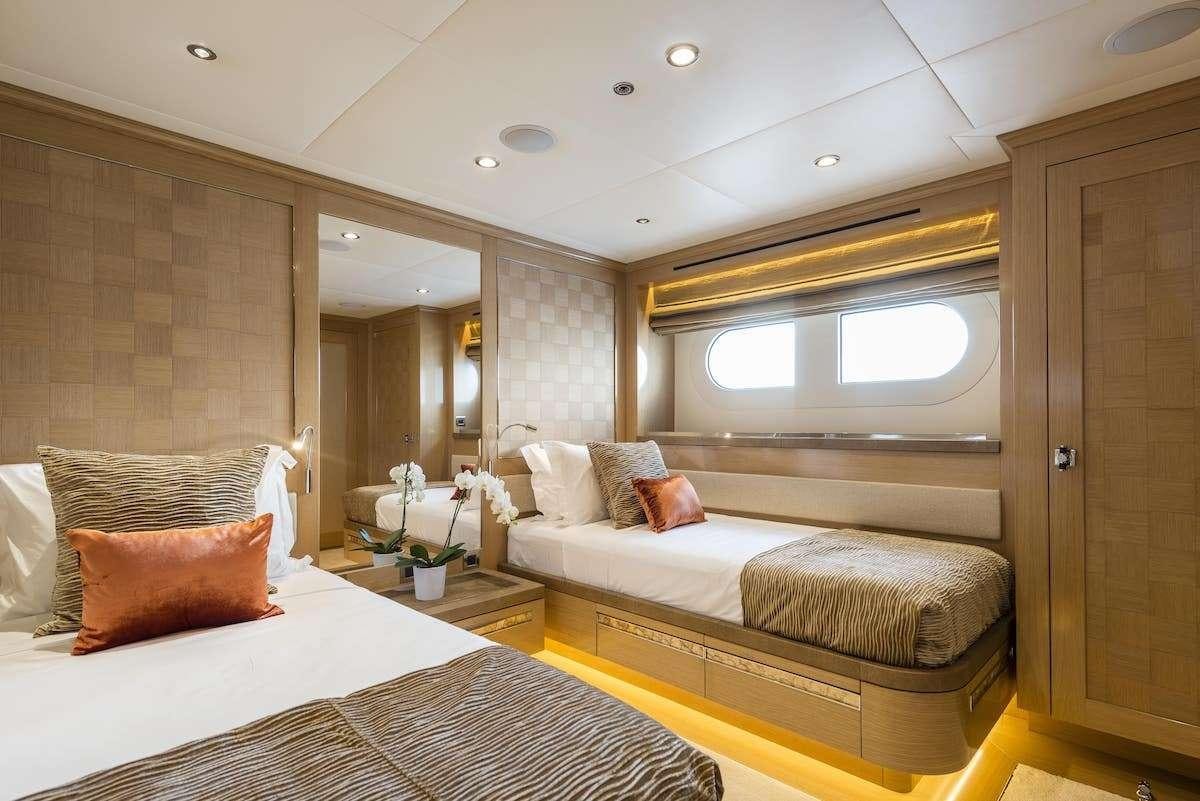 a room with a bed and a couch aboard AUDACES Yacht for Charter