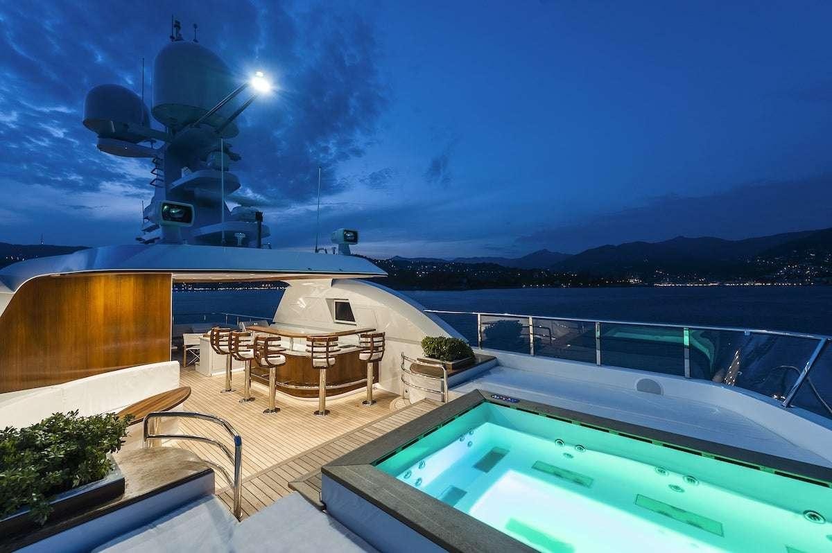 a pool with a fire in the background aboard AUDACES Yacht for Charter