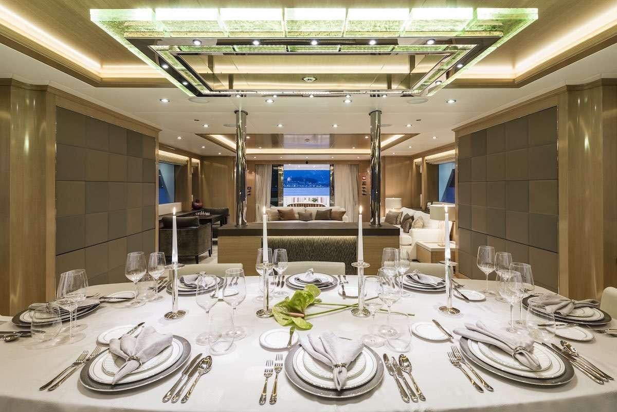 a table set with plates and glasses aboard AUDACES Yacht for Charter