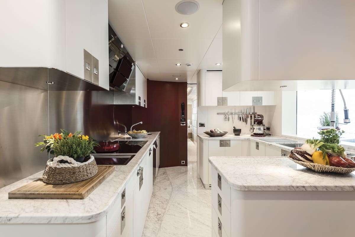 a kitchen with white cabinets aboard AUDACES Yacht for Charter