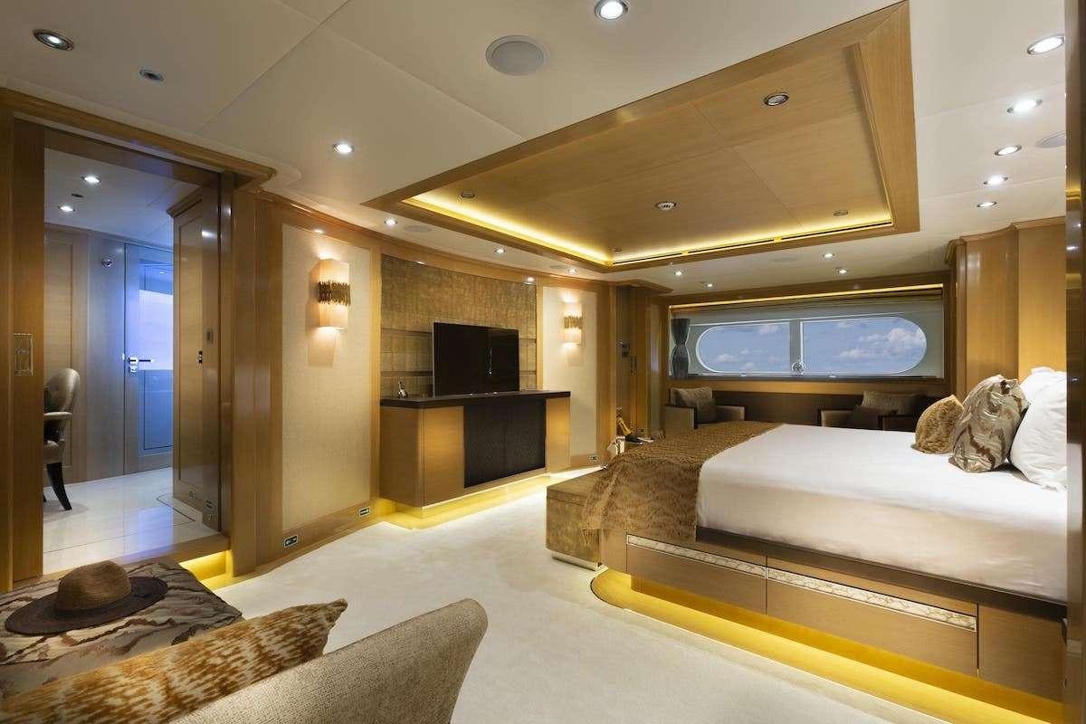 a room with a bed and a tv aboard AUDACES Yacht for Charter