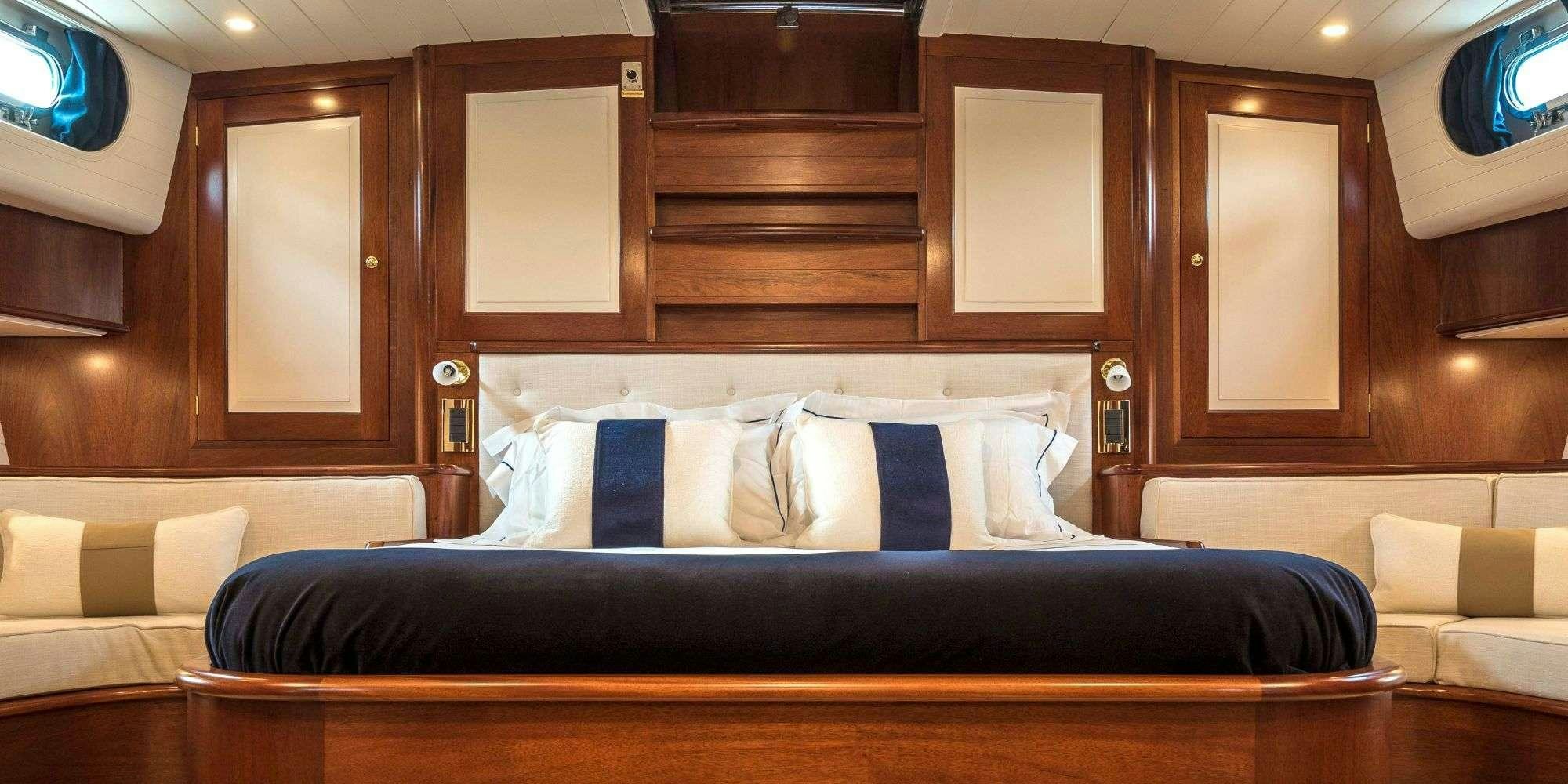a bed with a black bed aboard IRELANDA Yacht for Charter