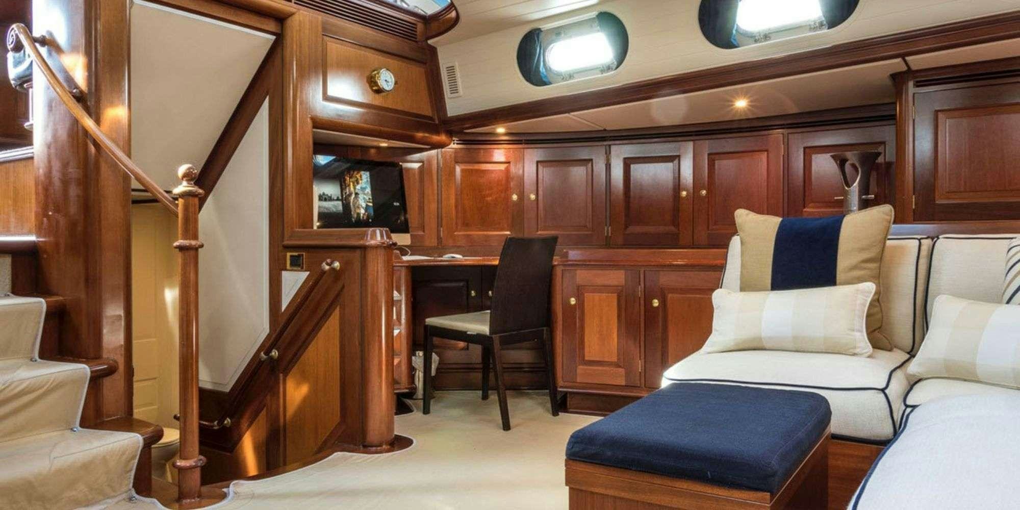 a room with a bed and a chair aboard IRELANDA Yacht for Charter
