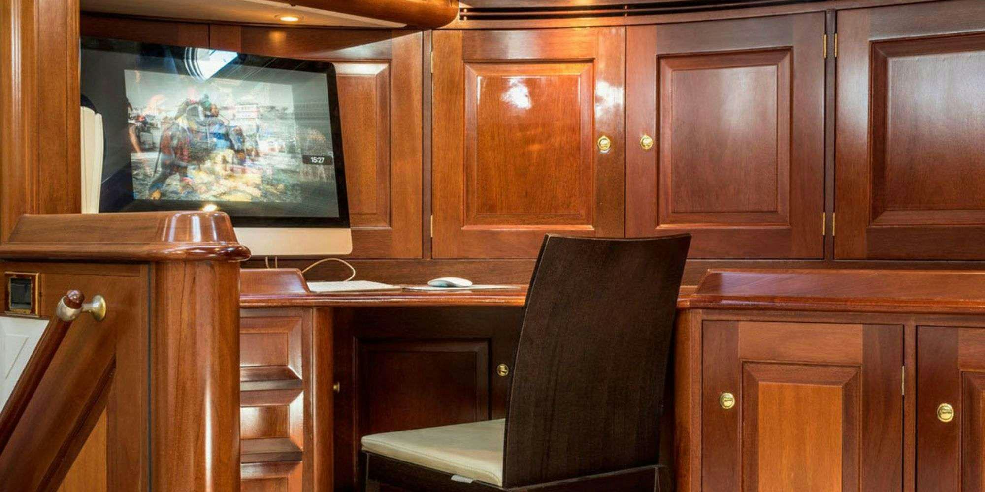 a room with a tv and cabinets aboard IRELANDA Yacht for Charter