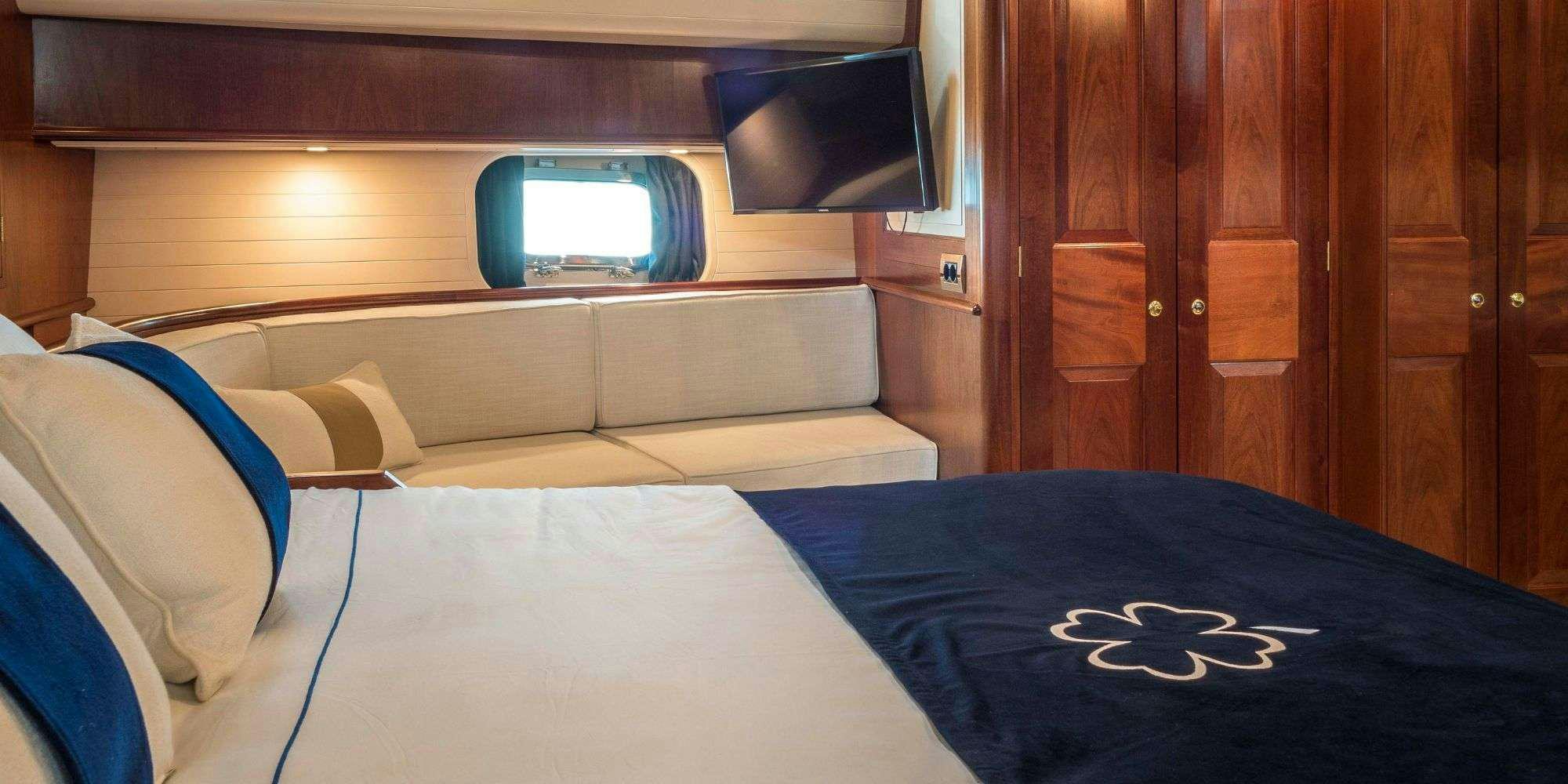 a bed with a blue blanket aboard IRELANDA Yacht for Charter