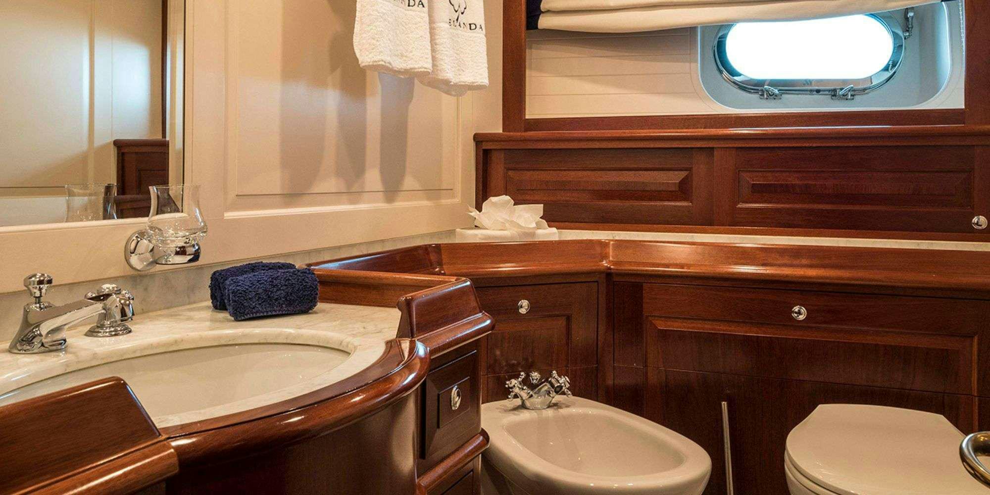 a bathroom with a sink and a mirror aboard IRELANDA Yacht for Charter