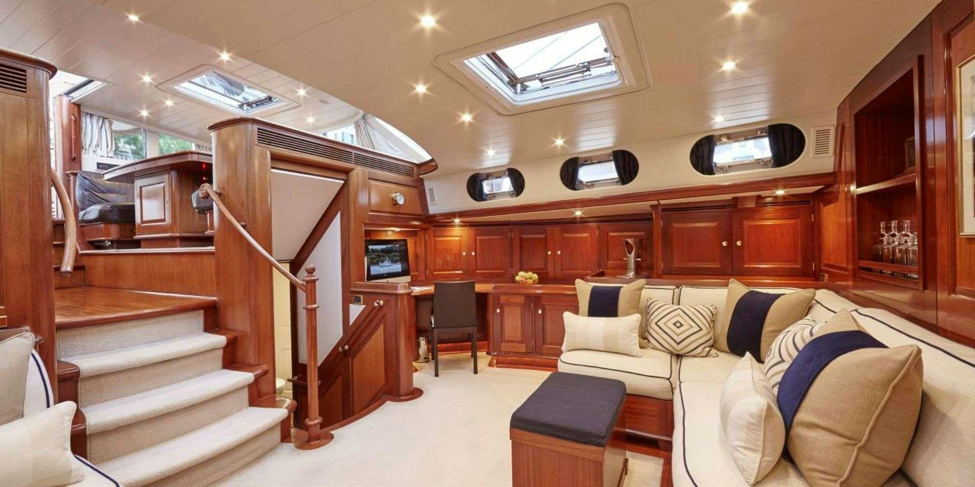 a room with a bed and a couch aboard IRELANDA Yacht for Charter