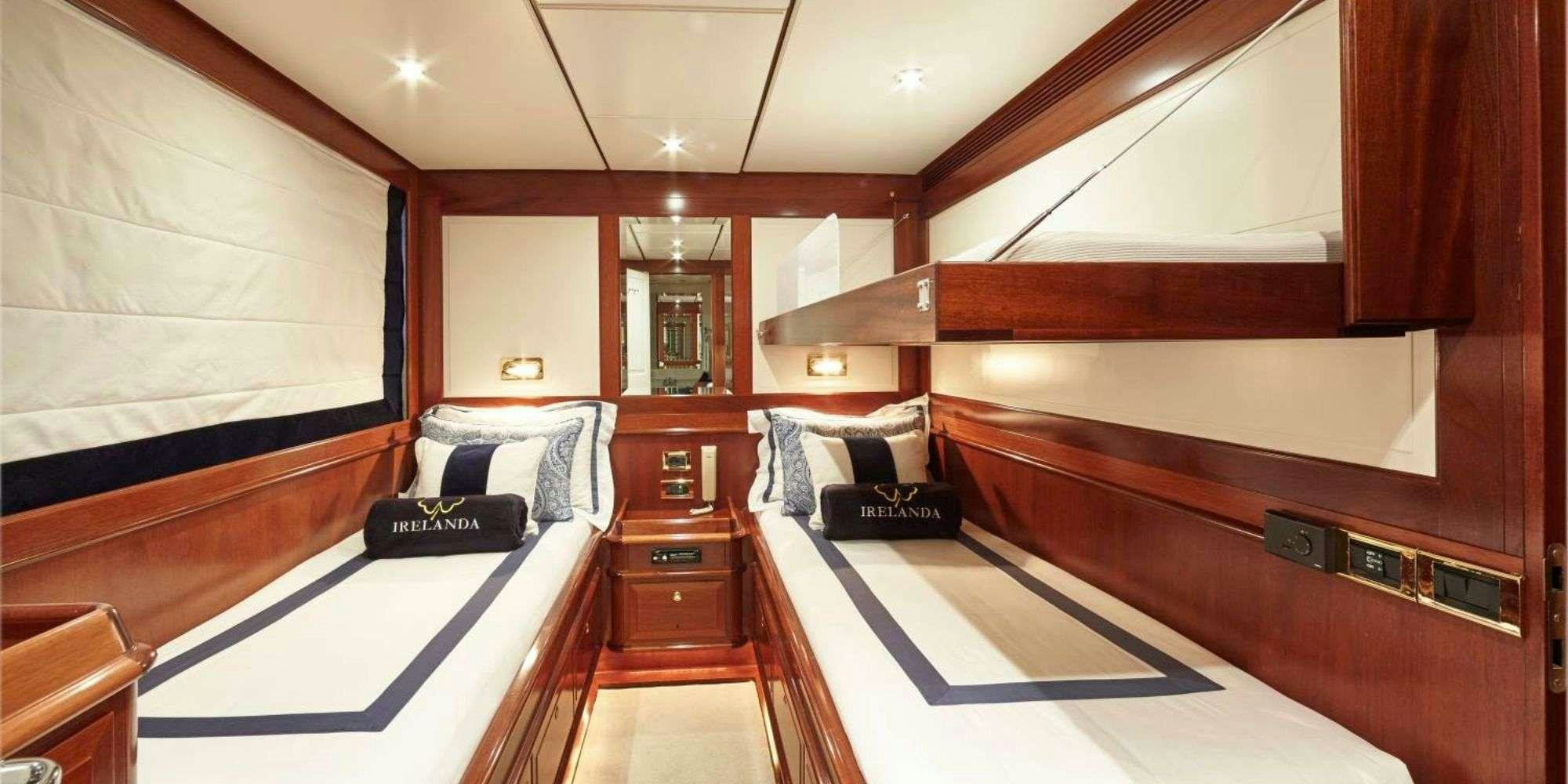 a room with a bed and a desk aboard IRELANDA Yacht for Charter