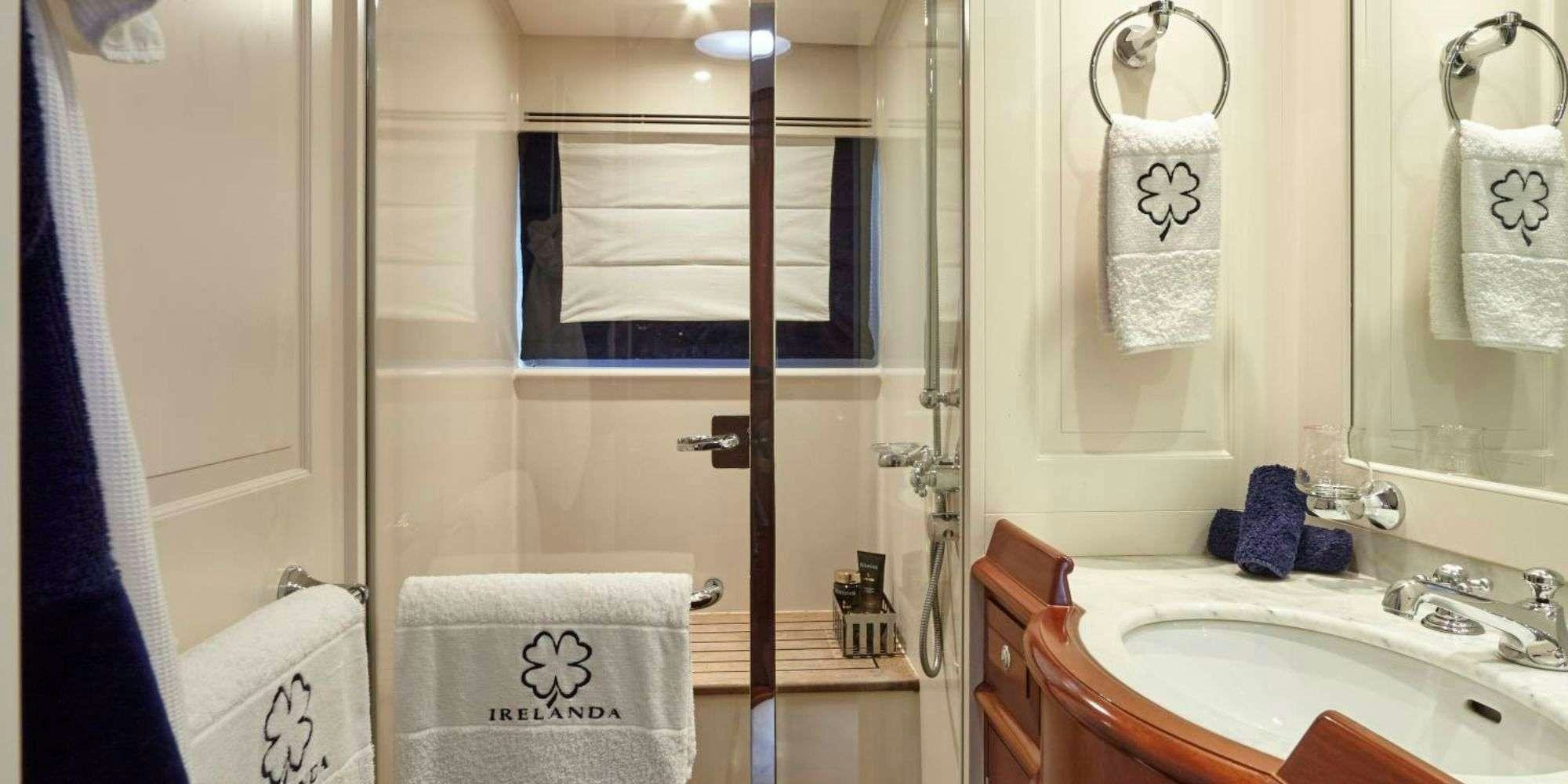 a bathroom with a sink and towels aboard IRELANDA Yacht for Charter