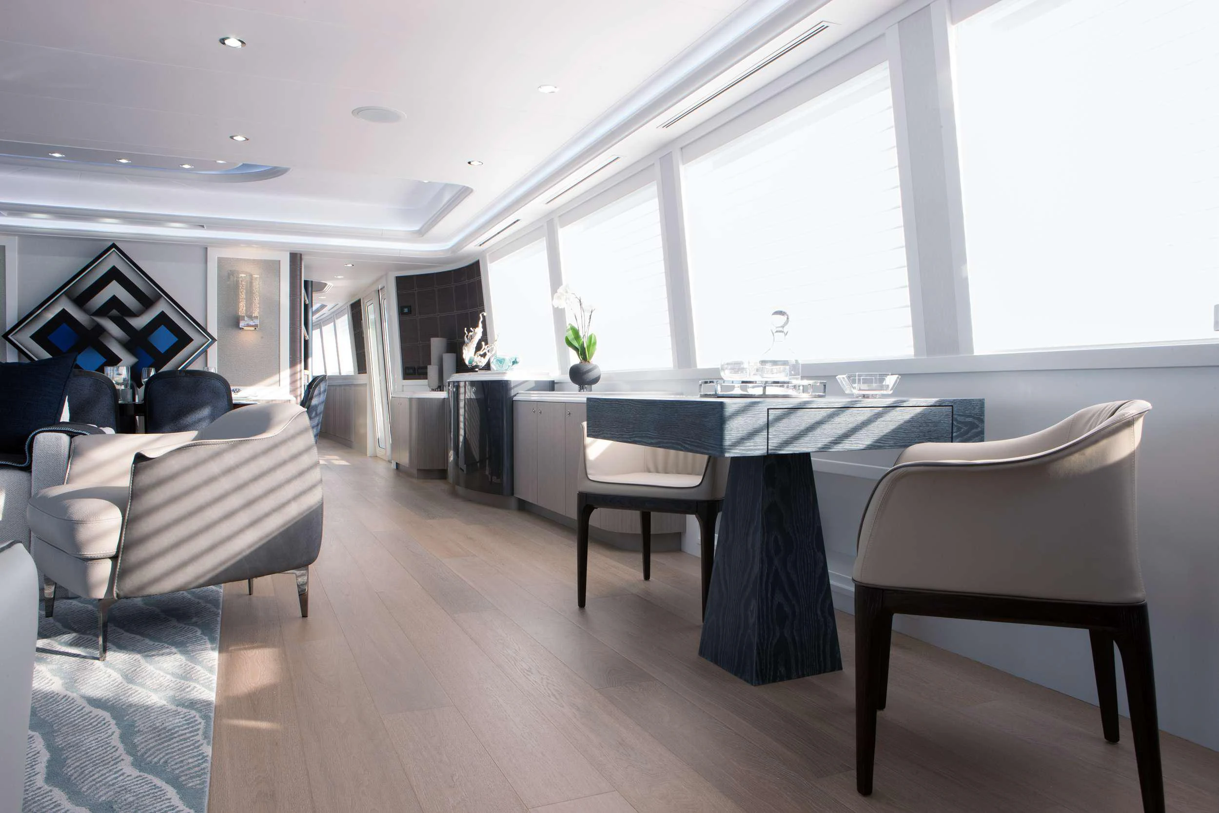 a room with a table chairs and a large window aboard HANNAH Yacht for Charter