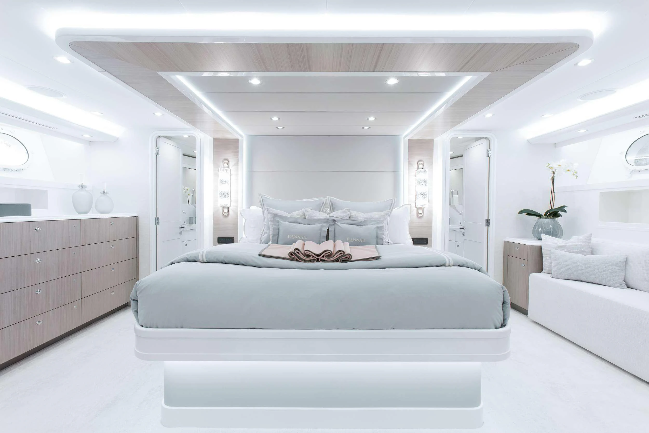 a white bedroom with a white couch aboard HANNAH Yacht for Charter