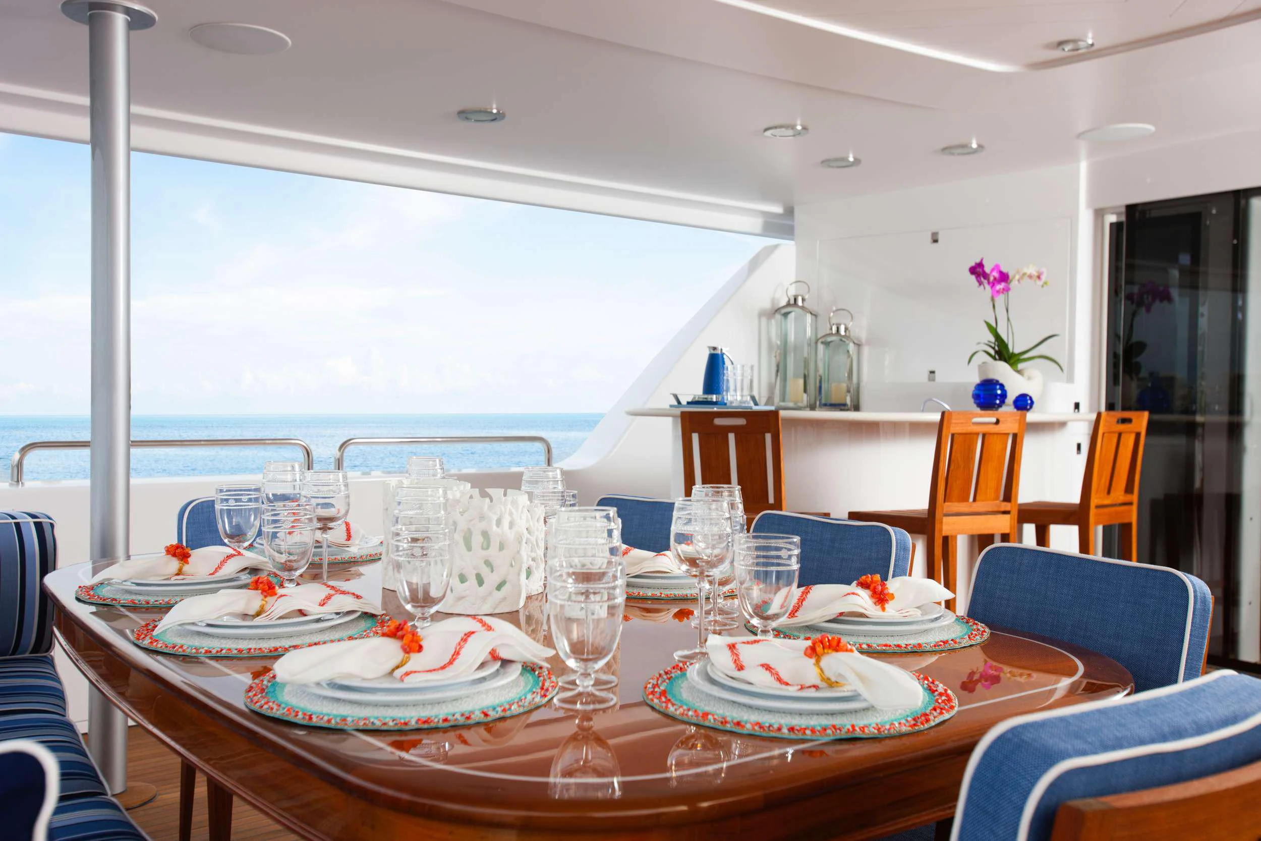 a table set with plates and glasses aboard HANNAH Yacht for Charter
