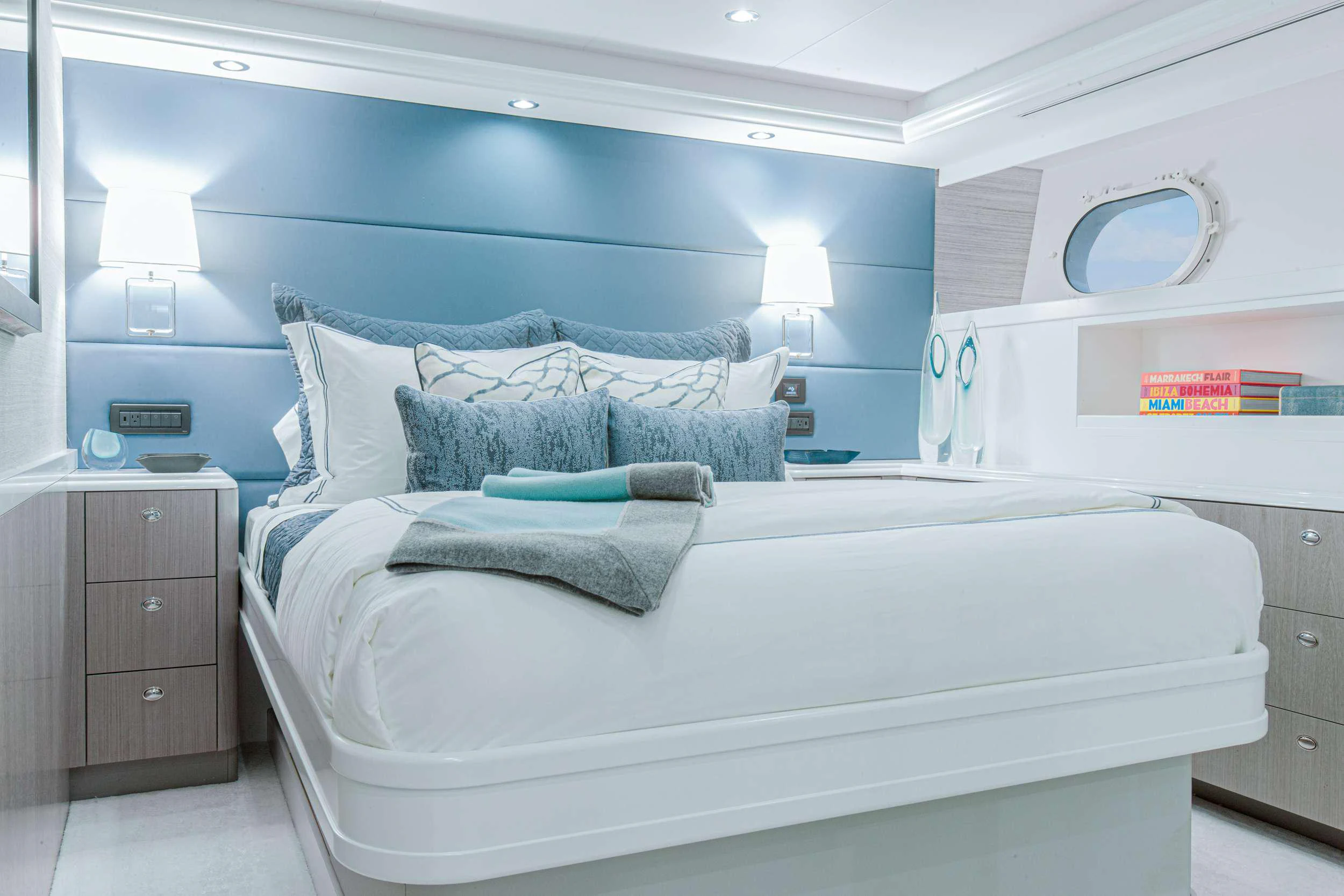 a bed with blue sheets aboard HANNAH Yacht for Charter
