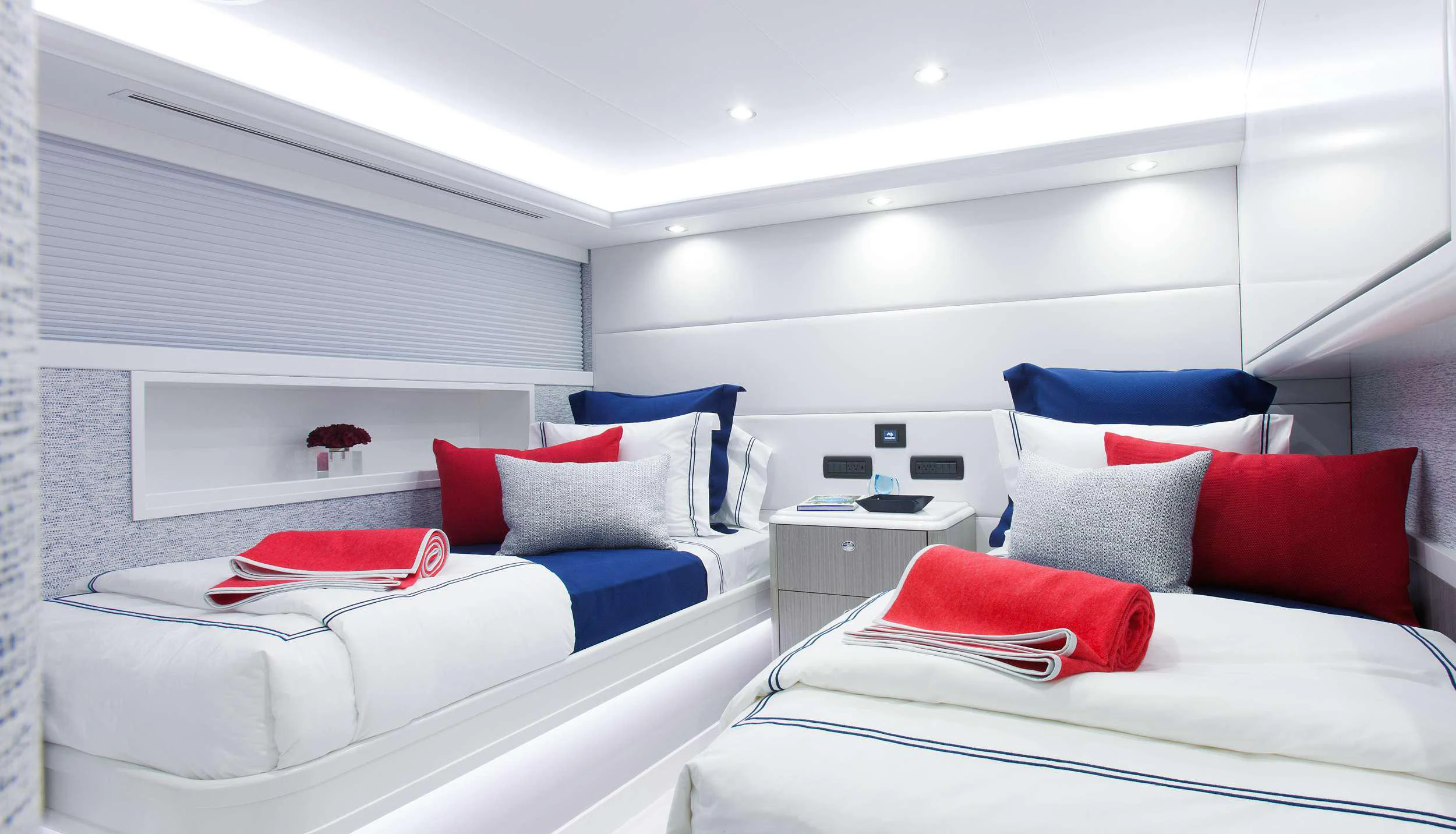 a room with white bedding and pillows aboard HANNAH Yacht for Charter
