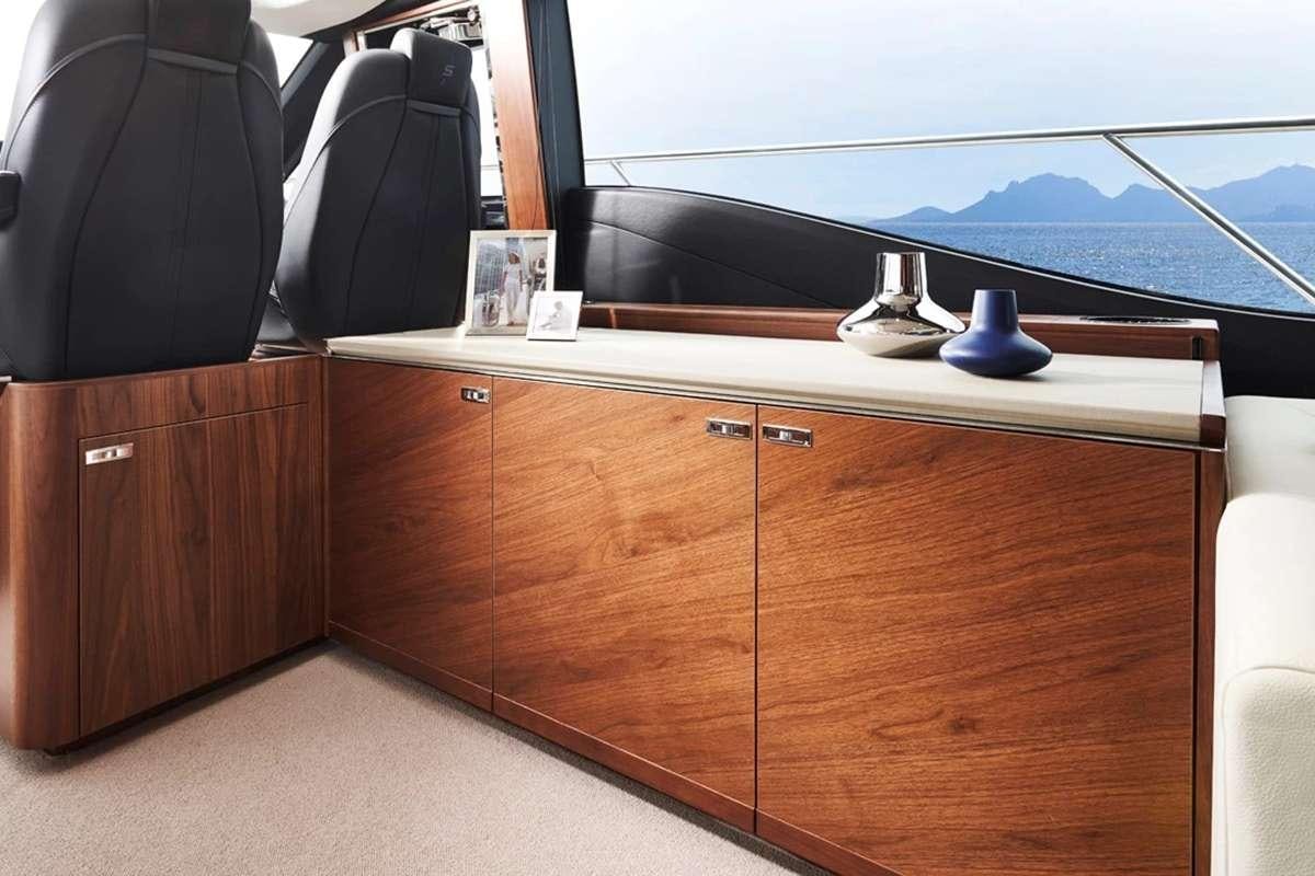 a desk with a computer and a window aboard CHAMELEON III Yacht for Charter