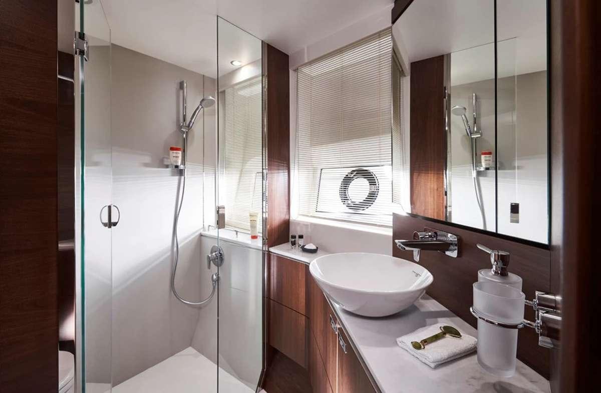 a bathroom with a sink and a shower aboard CHAMELEON III Yacht for Charter