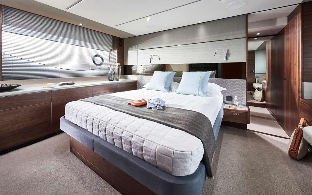 a room with a bed and a desk aboard CHAMELEON III Yacht for Charter