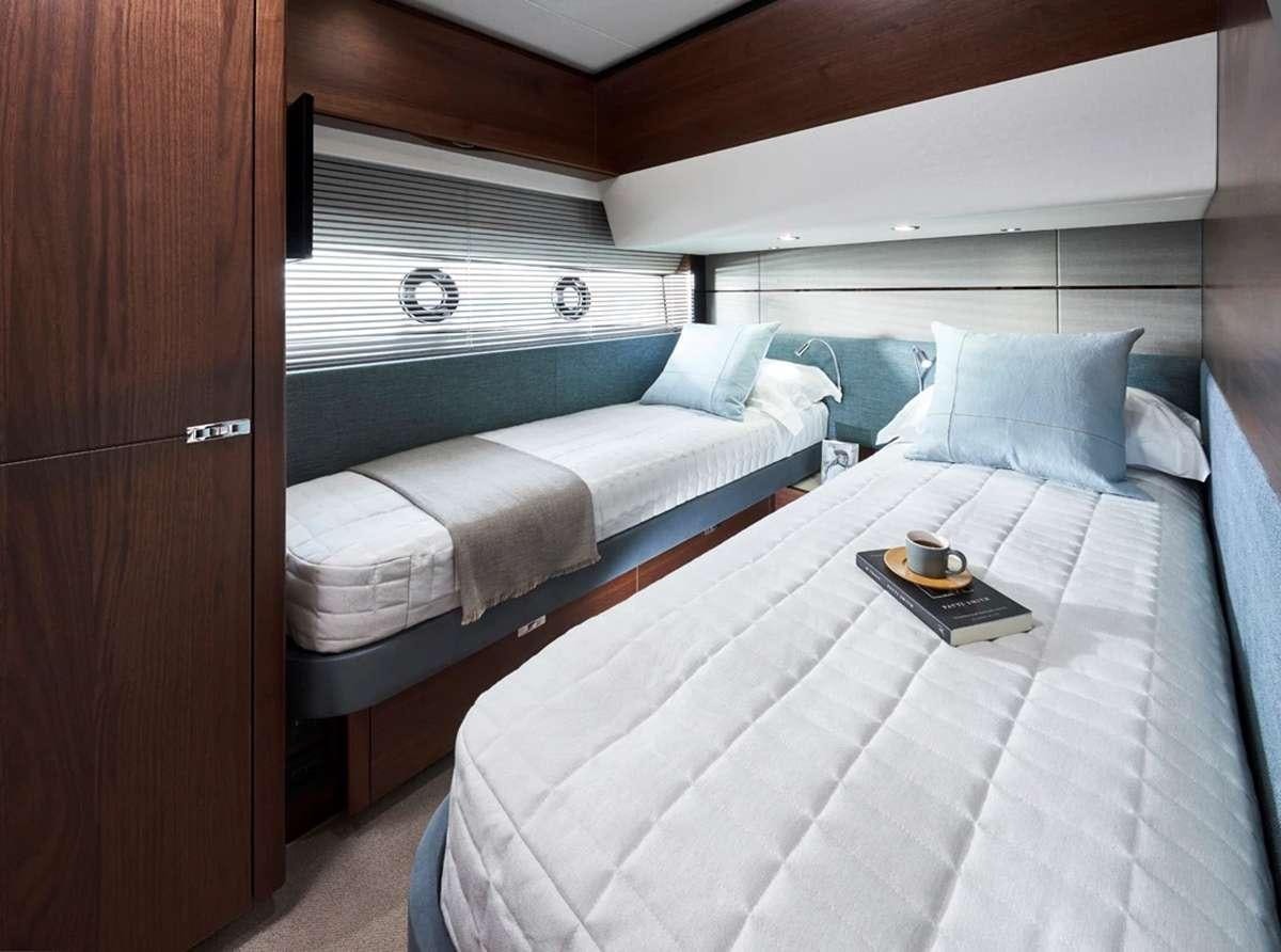 a couple of beds in a room aboard CHAMELEON III Yacht for Charter