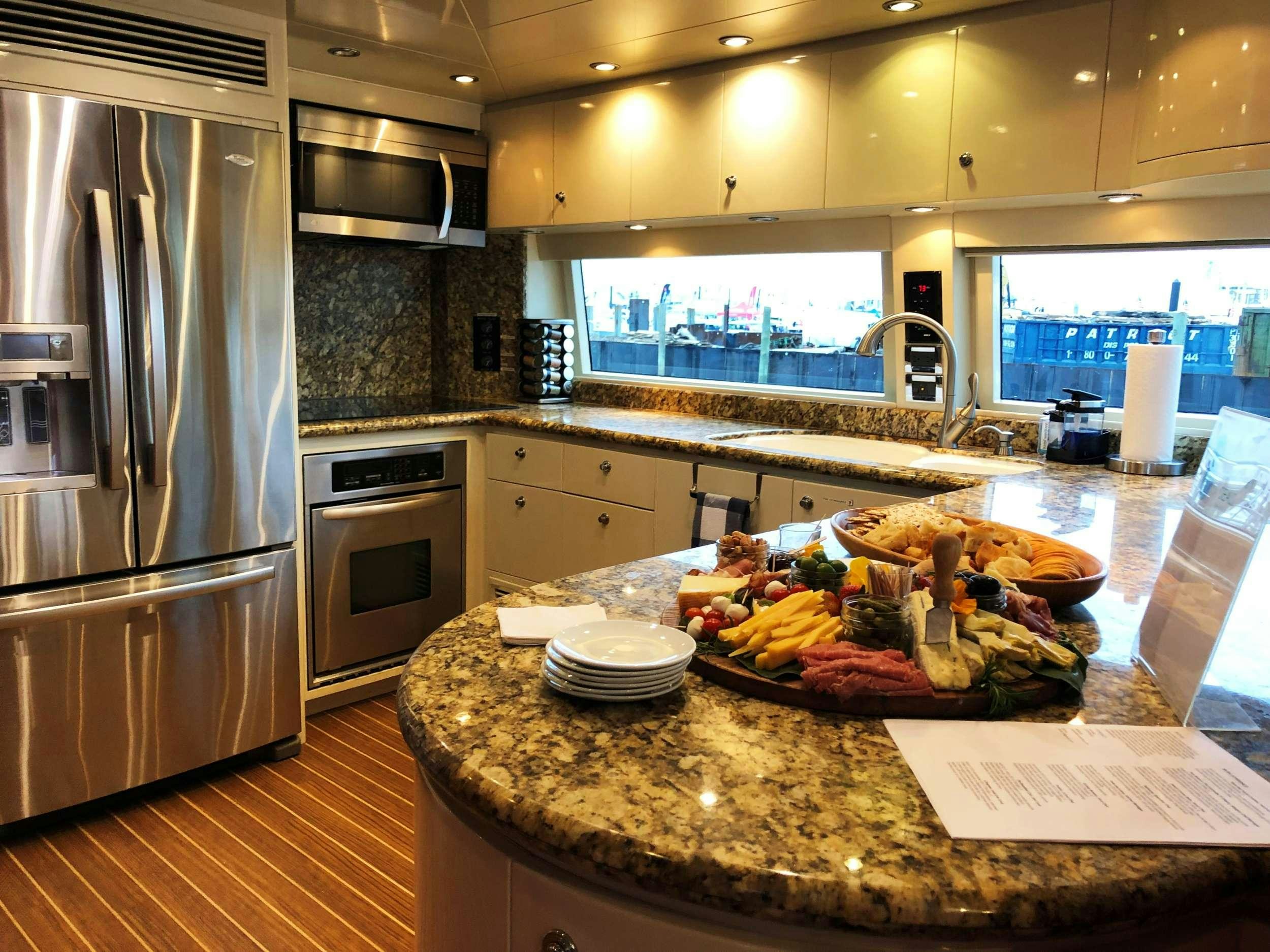 a kitchen with a large island aboard TRIPLE NET Yacht for Charter