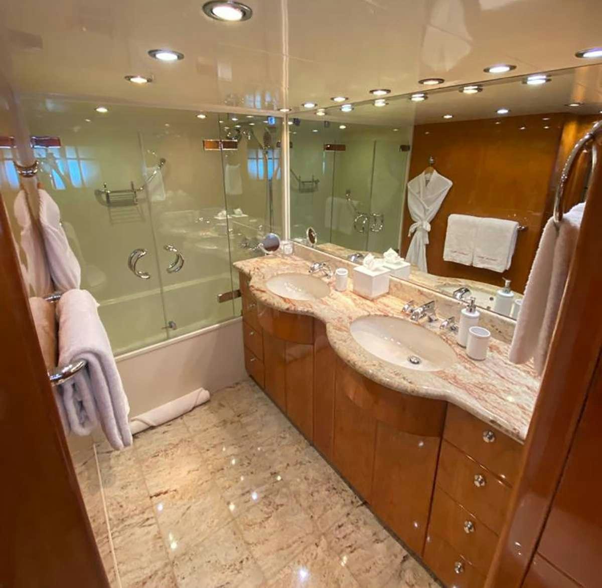 a bathroom with a large mirror aboard TRIPLE NET Yacht for Charter