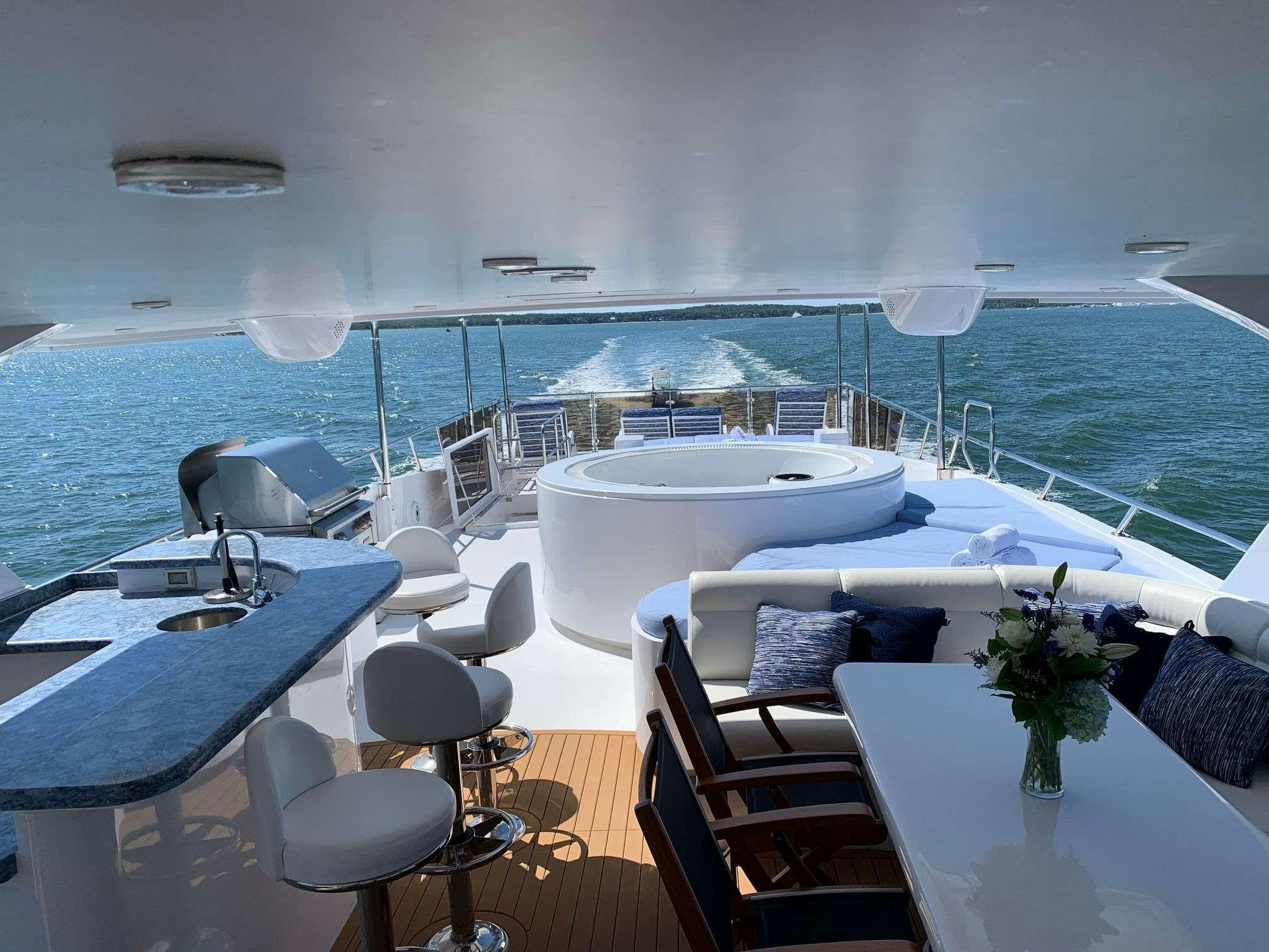 a room with a table chairs and a large body of water aboard TRIPLE NET Yacht for Charter