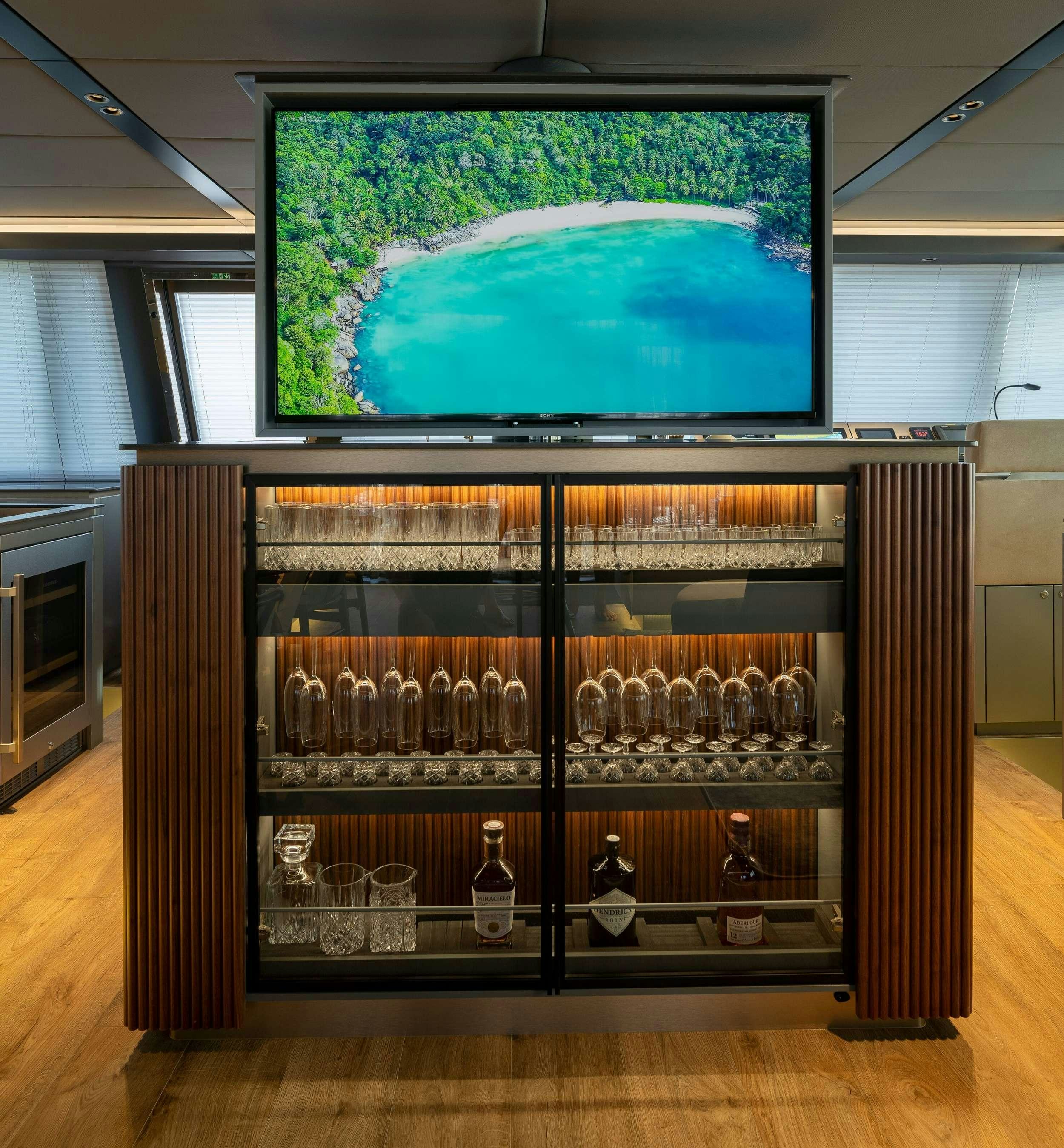 a glass display case with a large screen on the wall aboard VIVA LA VIDA Yacht for Charter