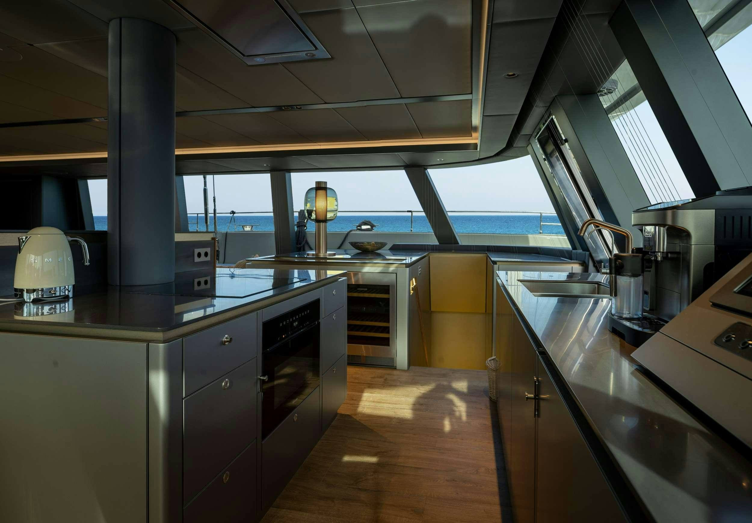 a kitchen with a large window aboard VIVA LA VIDA Yacht for Charter