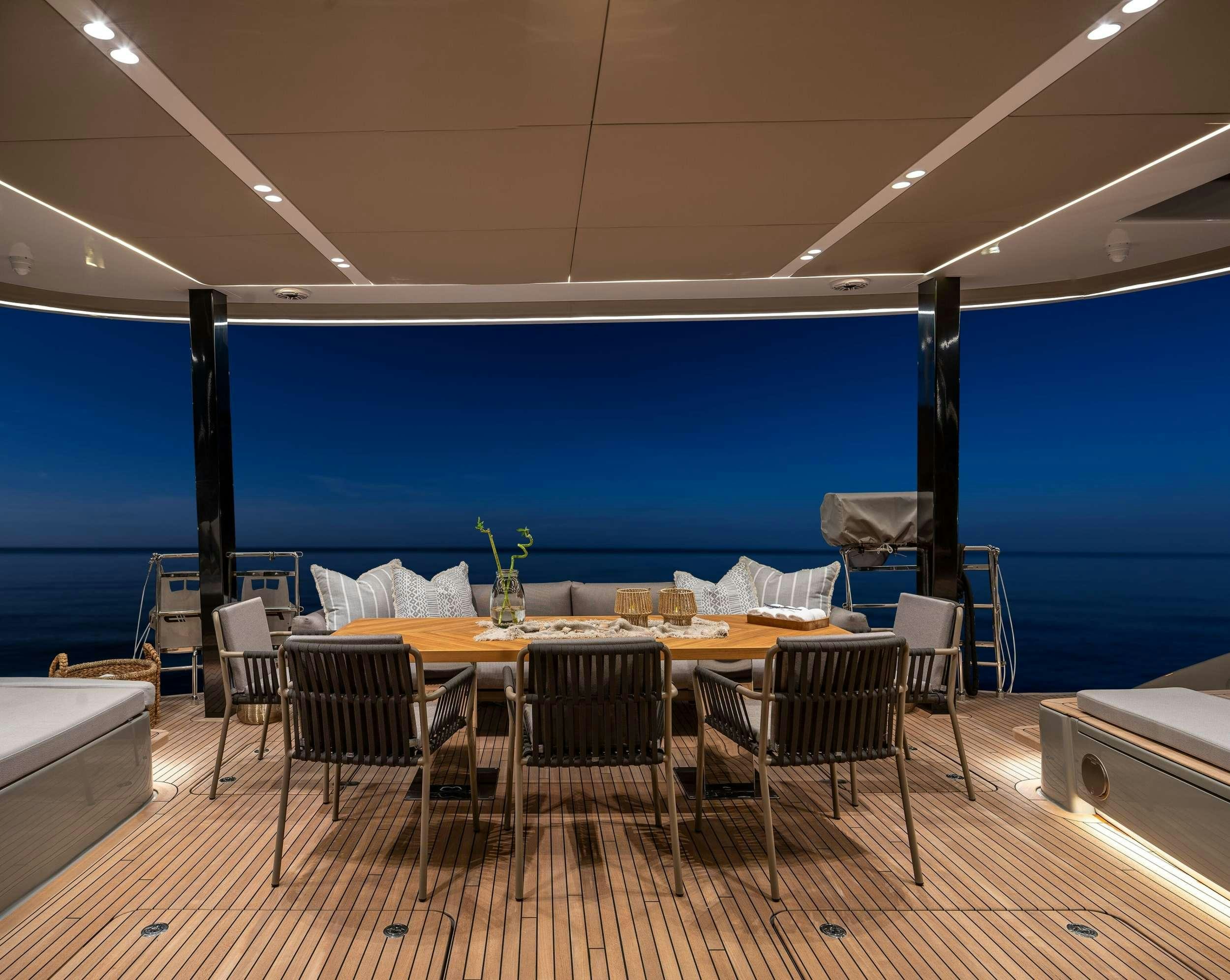 a room with a table and chairs aboard VIVA LA VIDA Yacht for Charter