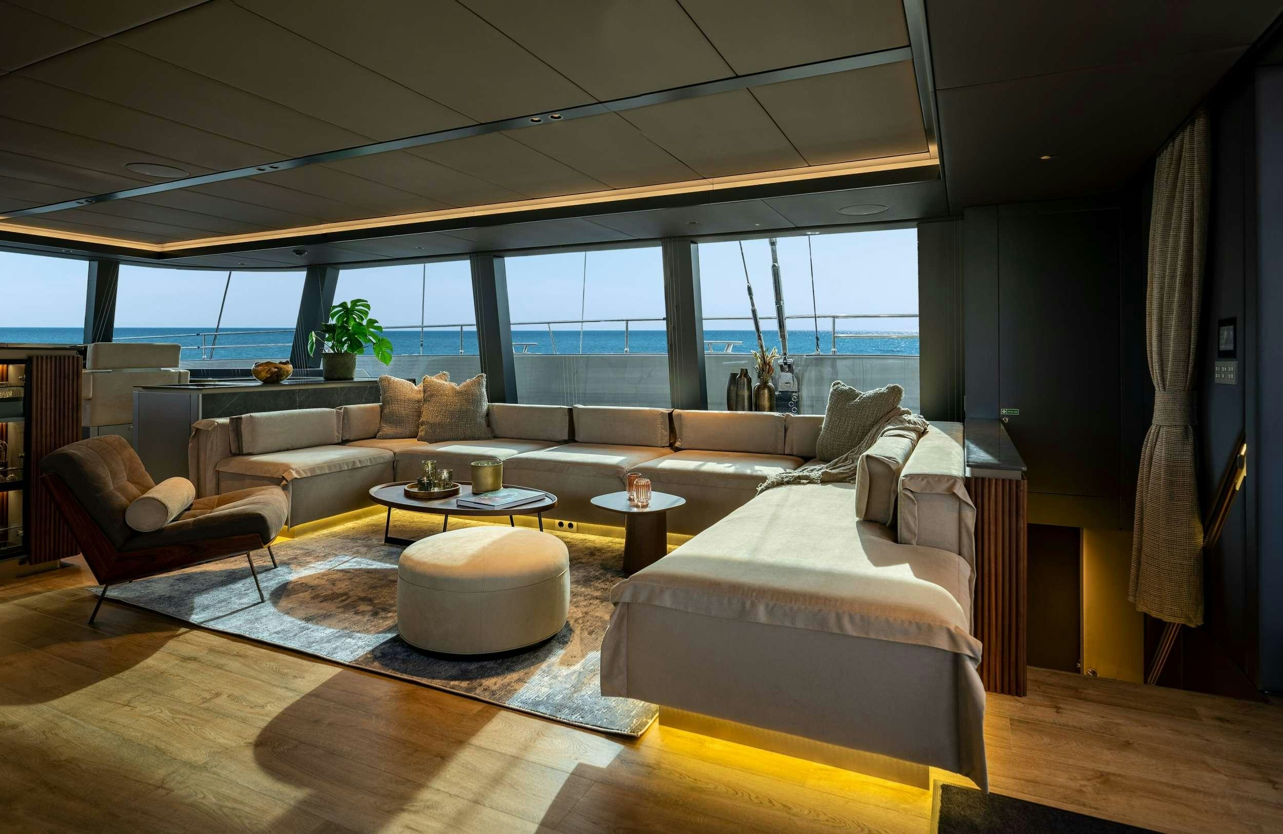a living room with a large window aboard VIVA LA VIDA Yacht for Charter