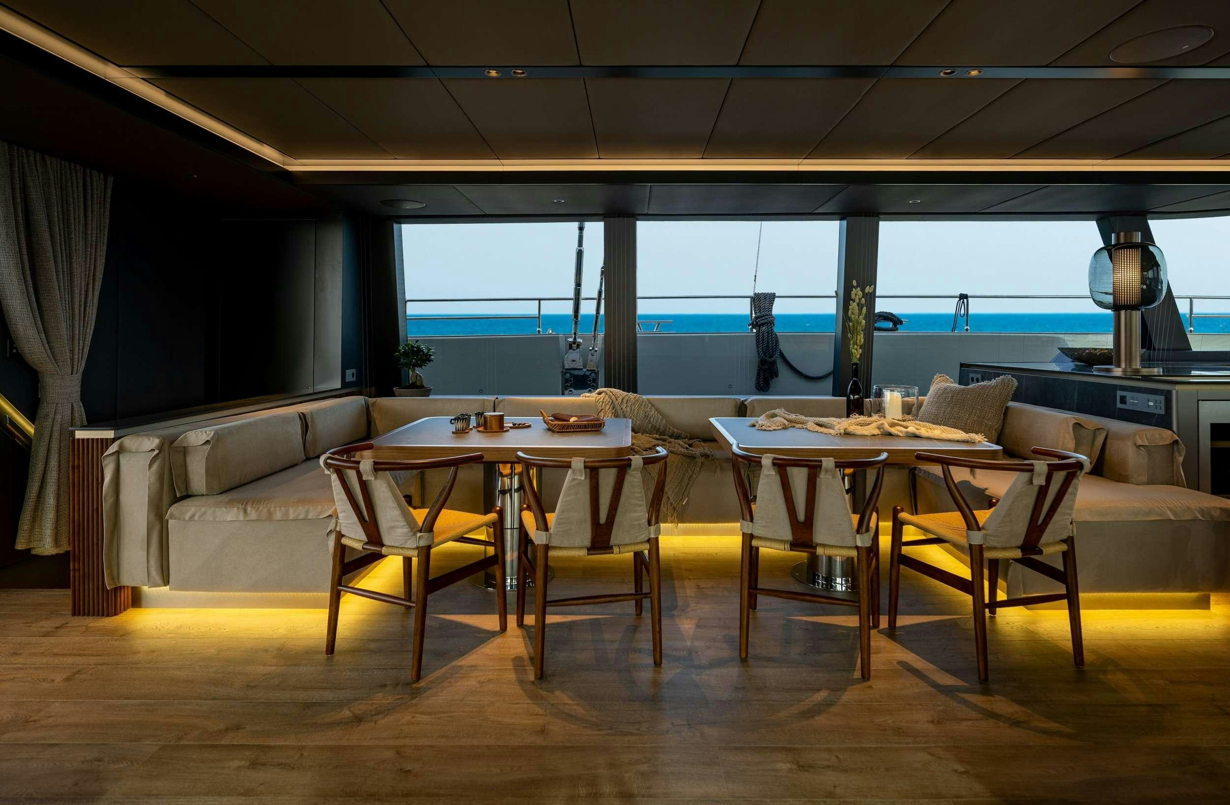 a room with tables and chairs aboard VIVA LA VIDA Yacht for Charter