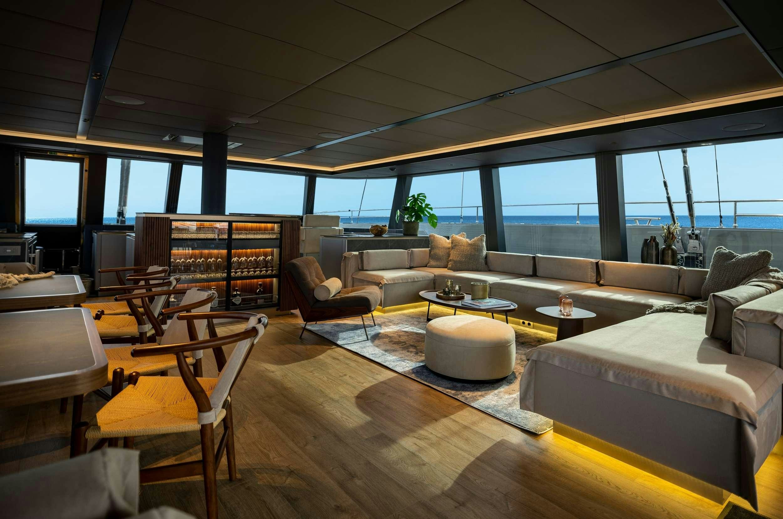 a living room with a large window aboard VIVA LA VIDA Yacht for Charter