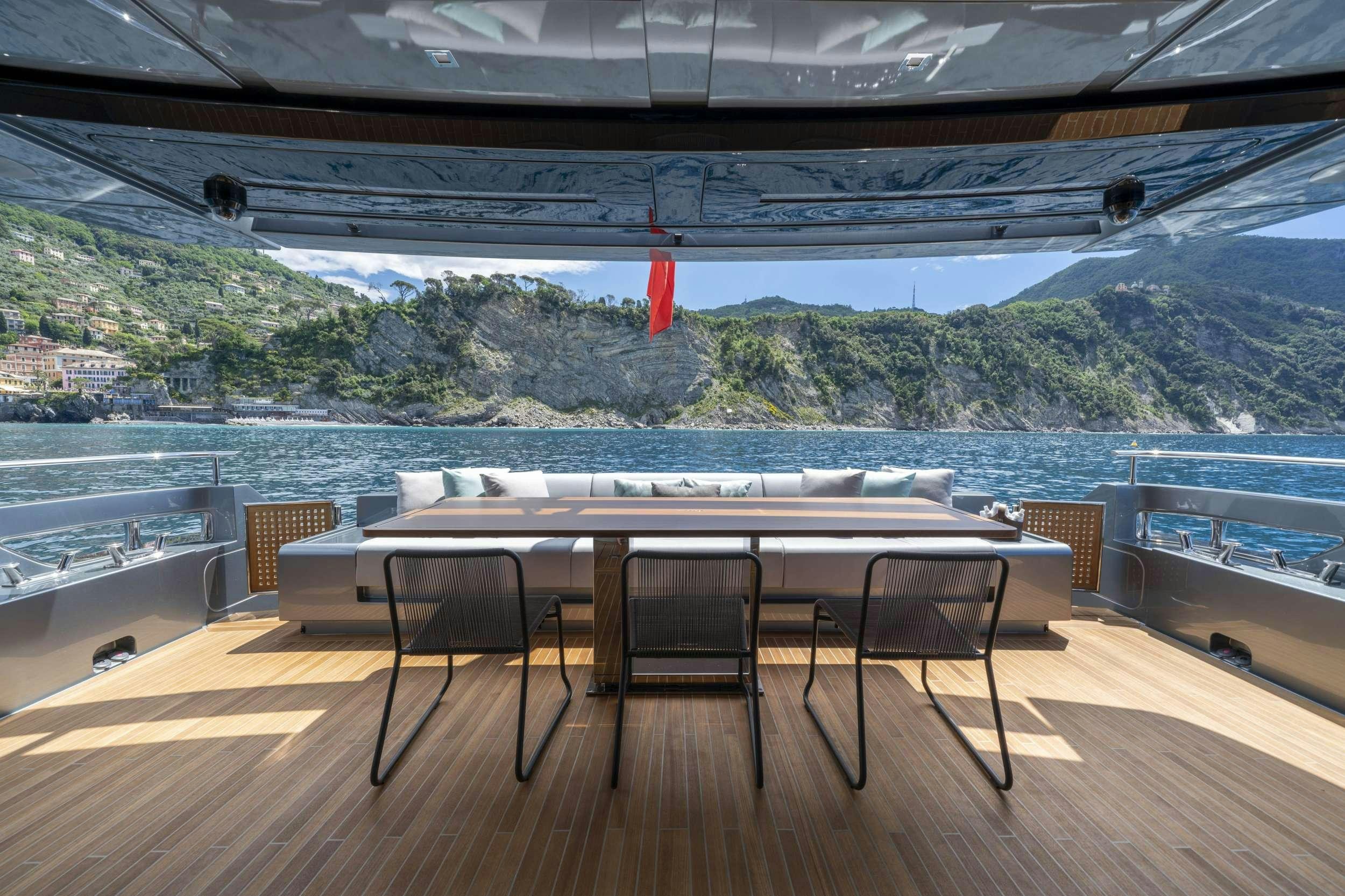 a table and chairs on a deck aboard MAXIMUS Yacht for Charter