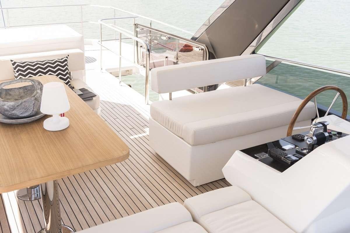 a living room with a couch and a coffee table aboard SIR HENDRIK Yacht for Charter