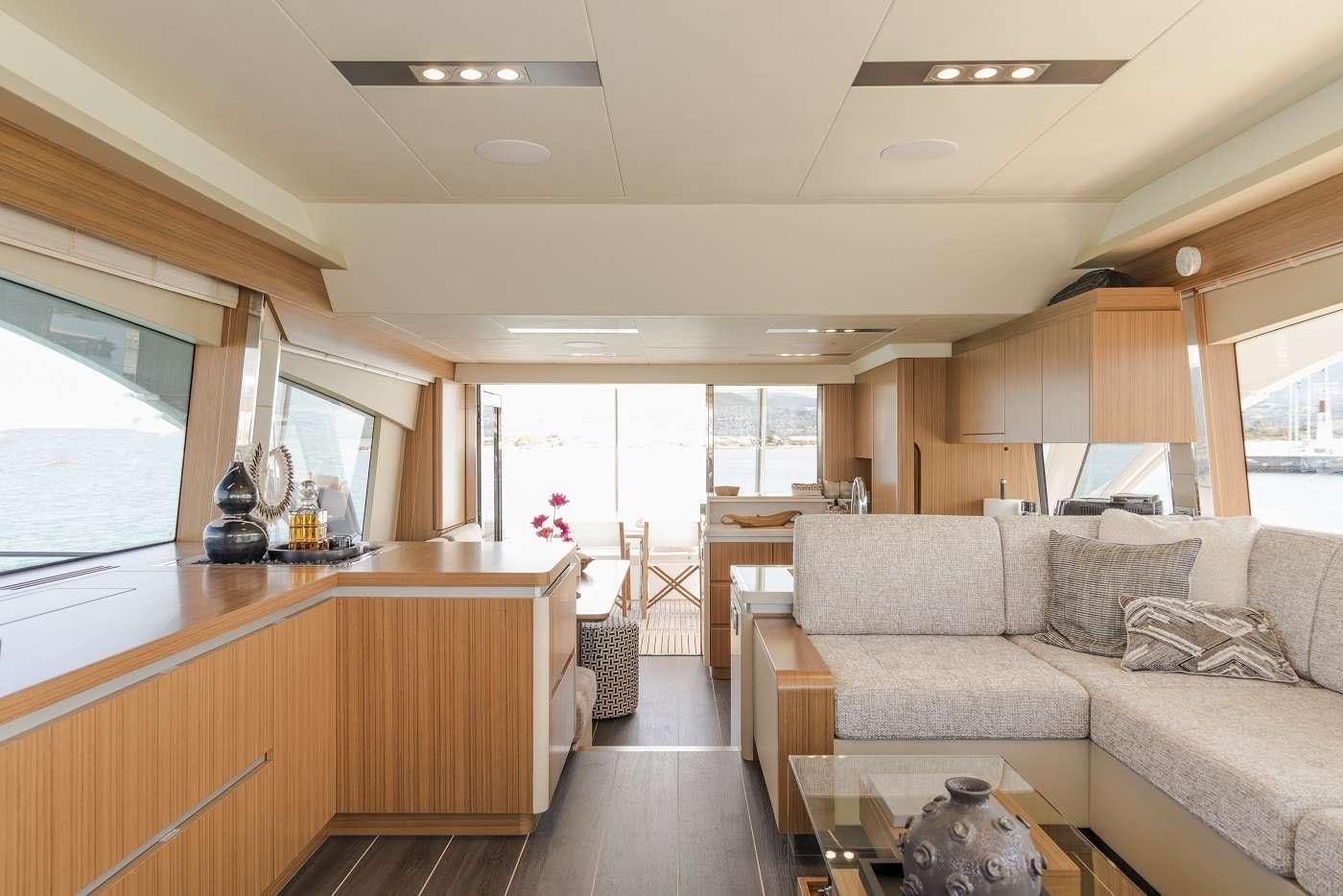a living room with a couch and a table aboard SIR HENDRIK Yacht for Charter