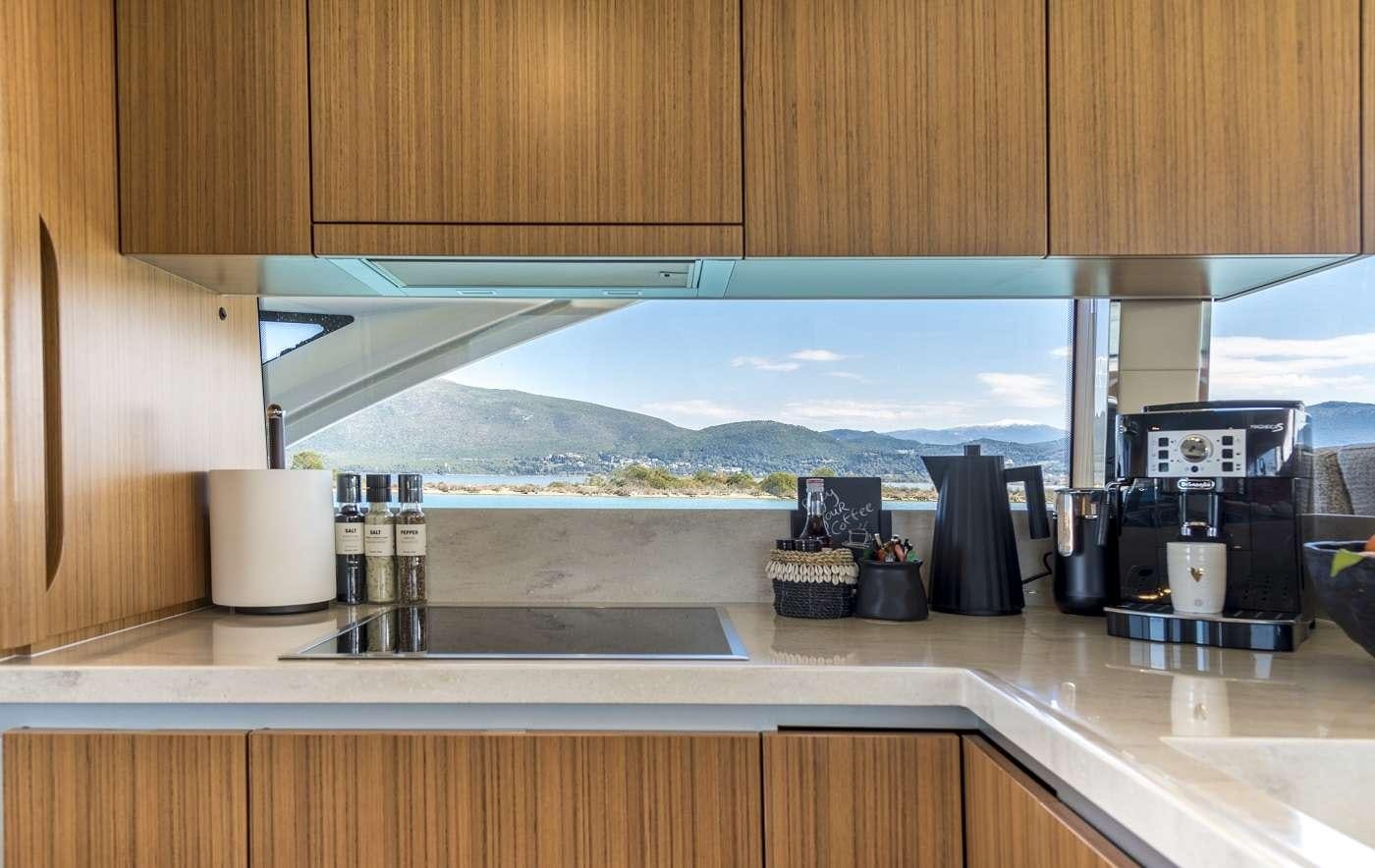 a kitchen with a large glass window aboard SIR HENDRIK Yacht for Charter