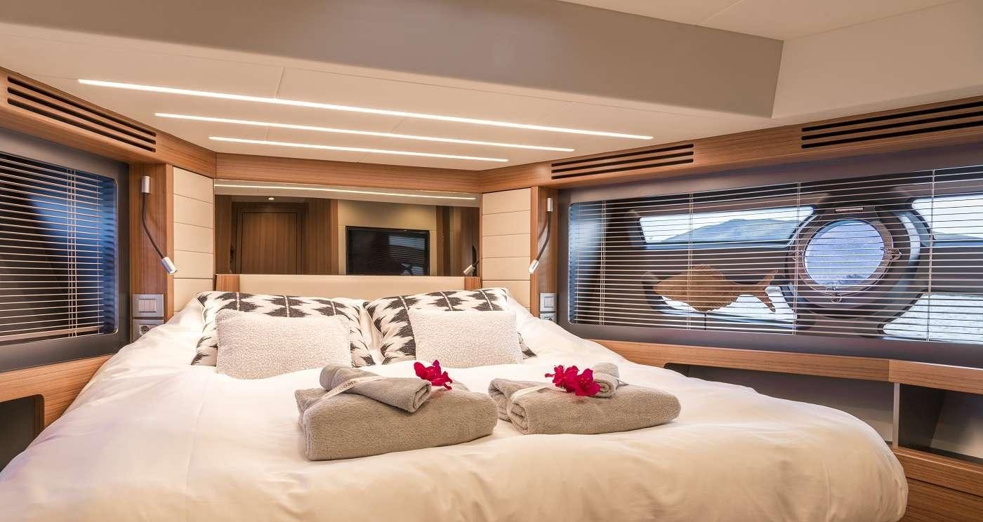 a large bed with a large window aboard SIR HENDRIK Yacht for Charter