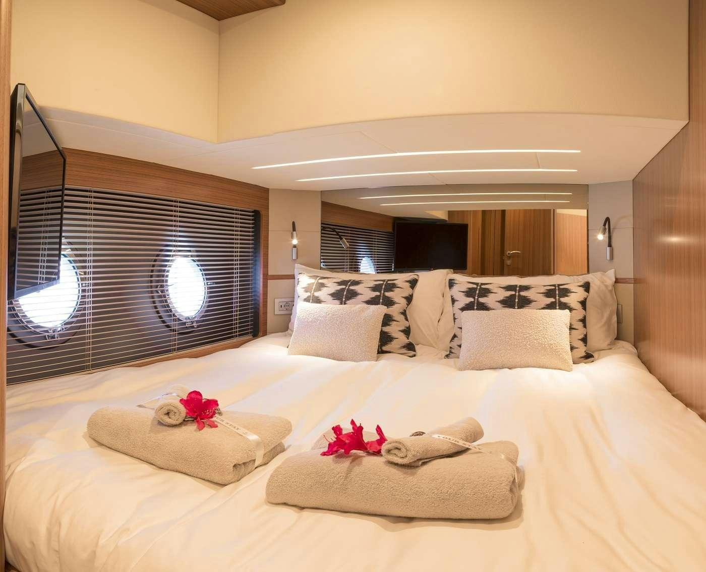 a bed with a white bed spread aboard SIR HENDRIK Yacht for Charter