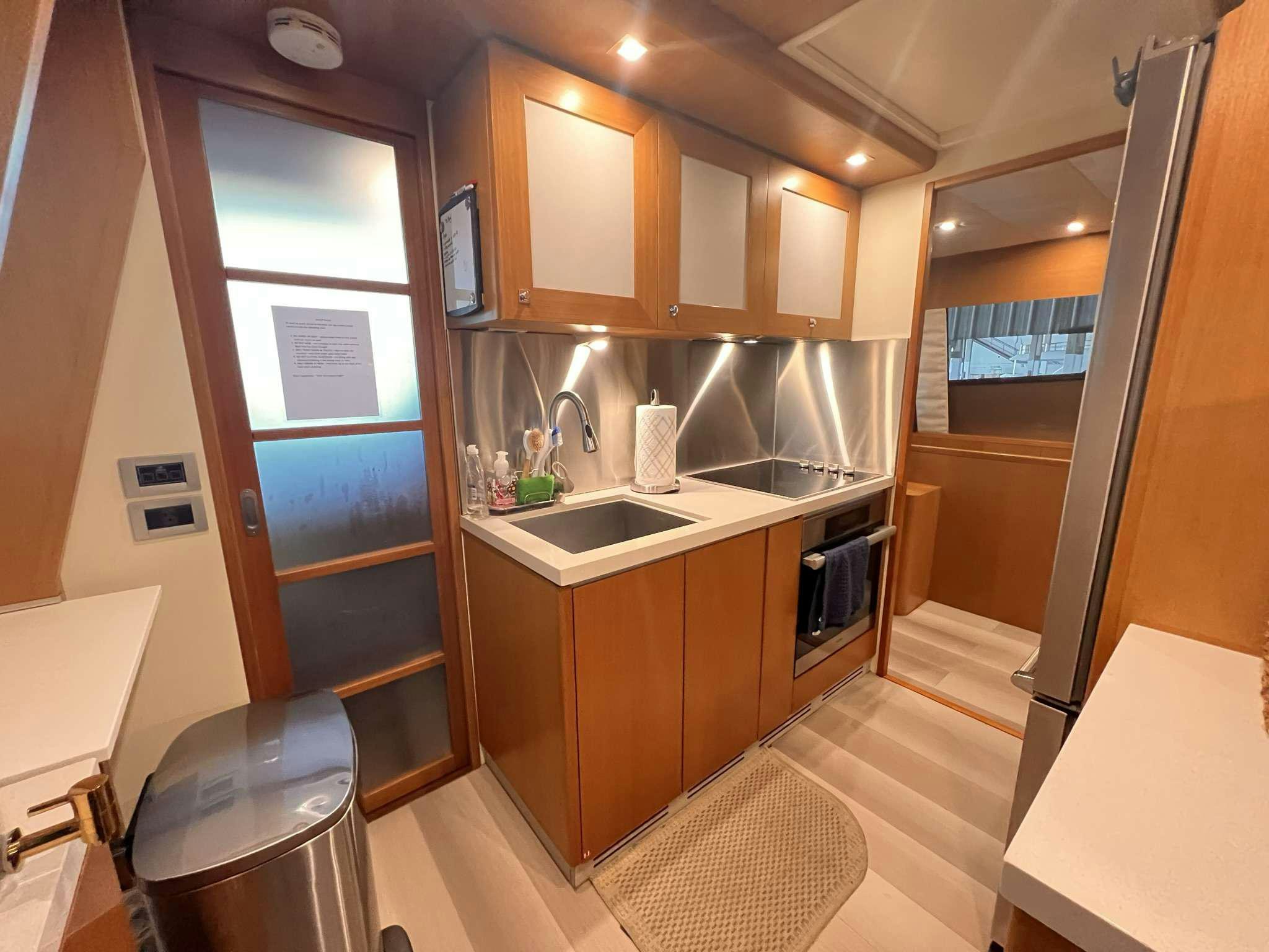 a kitchen with a sink and a refrigerator aboard DESTINY Yacht for Charter