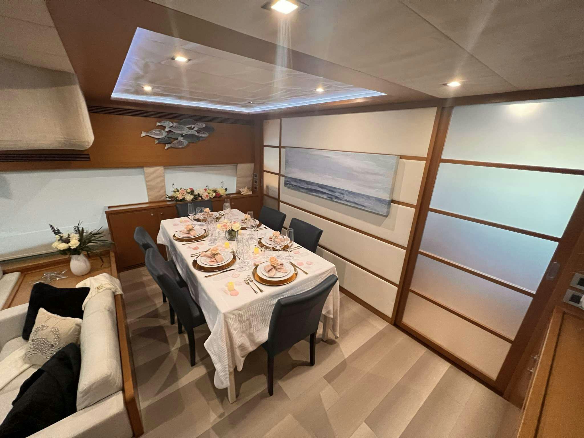 a dining table with a set of chairs and a couch aboard DESTINY Yacht for Charter