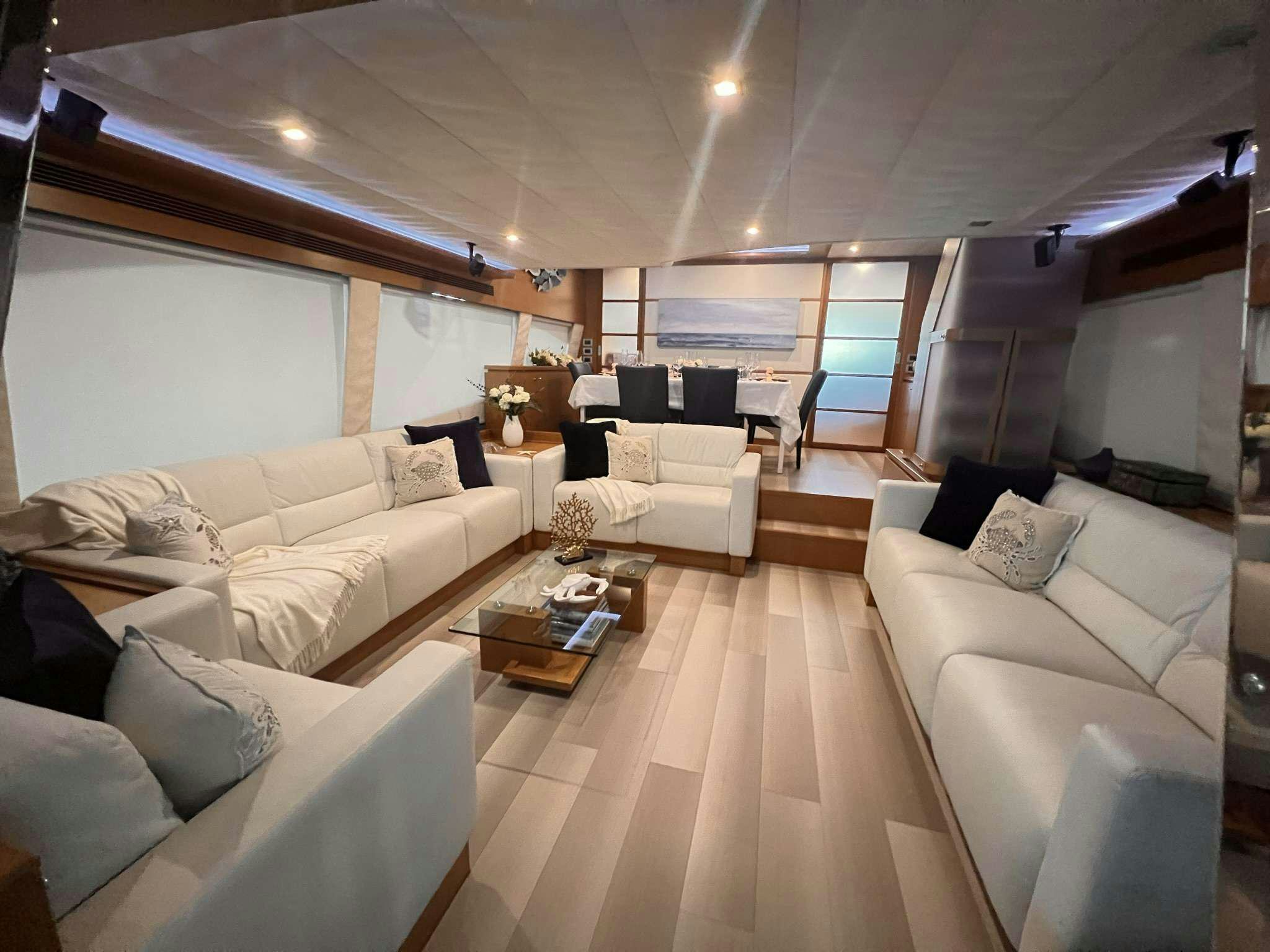 a living room with white couches aboard DESTINY Yacht for Charter