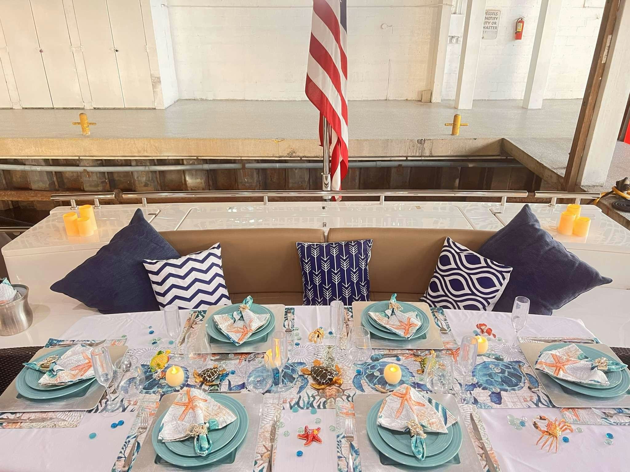 a table with a flag and plates aboard DESTINY Yacht for Charter
