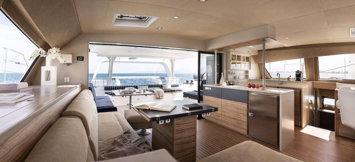 a room with a couch and a table and a window aboard NEPTUNE Yacht for Charter