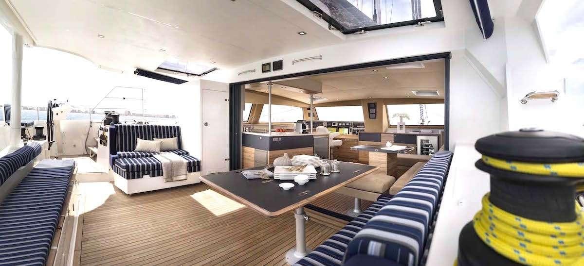 a room with a table and couches aboard NEPTUNE Yacht for Charter