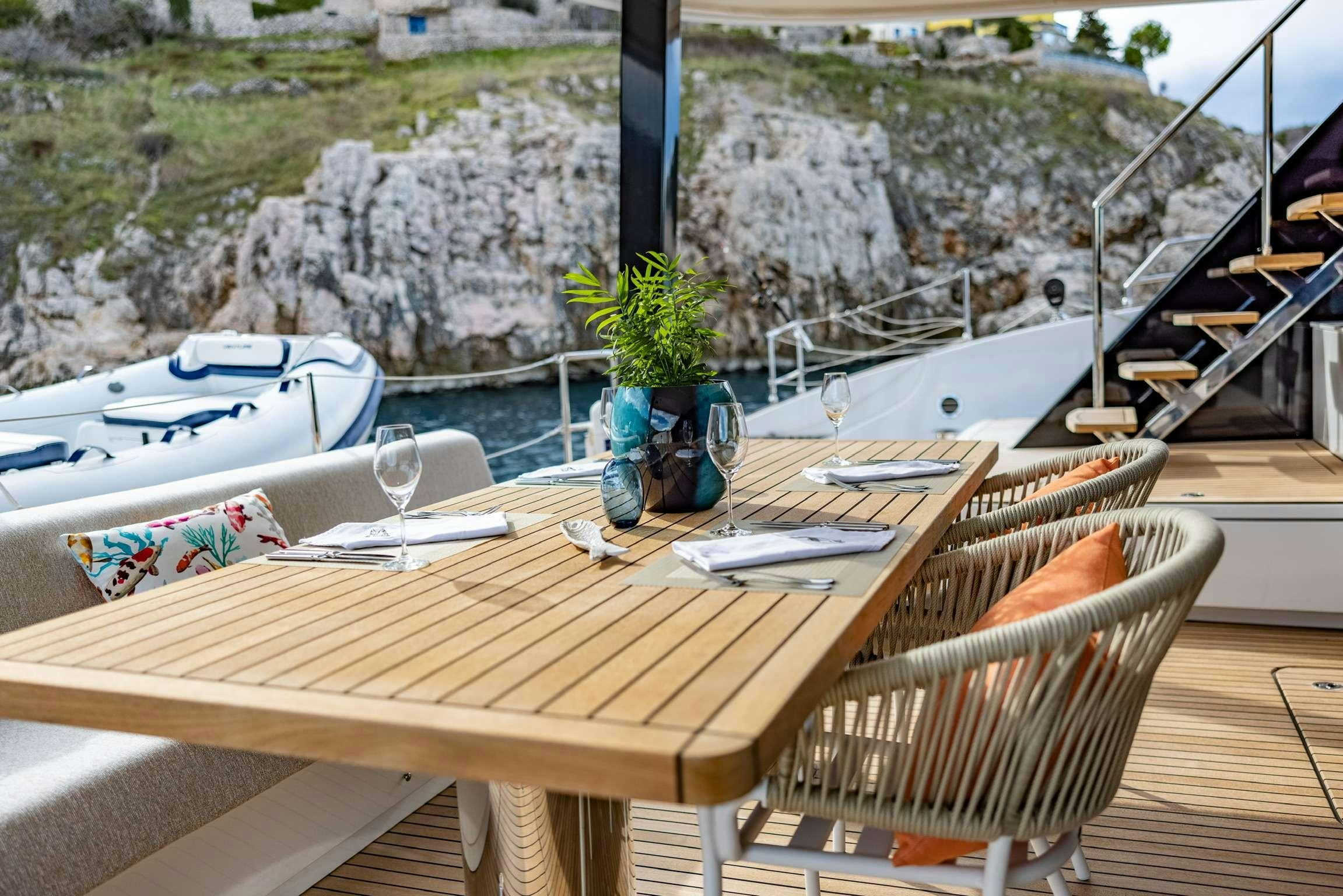 a table with a plant on it aboard SUNREEF 80 FANTASTIC TOO Yacht for Charter