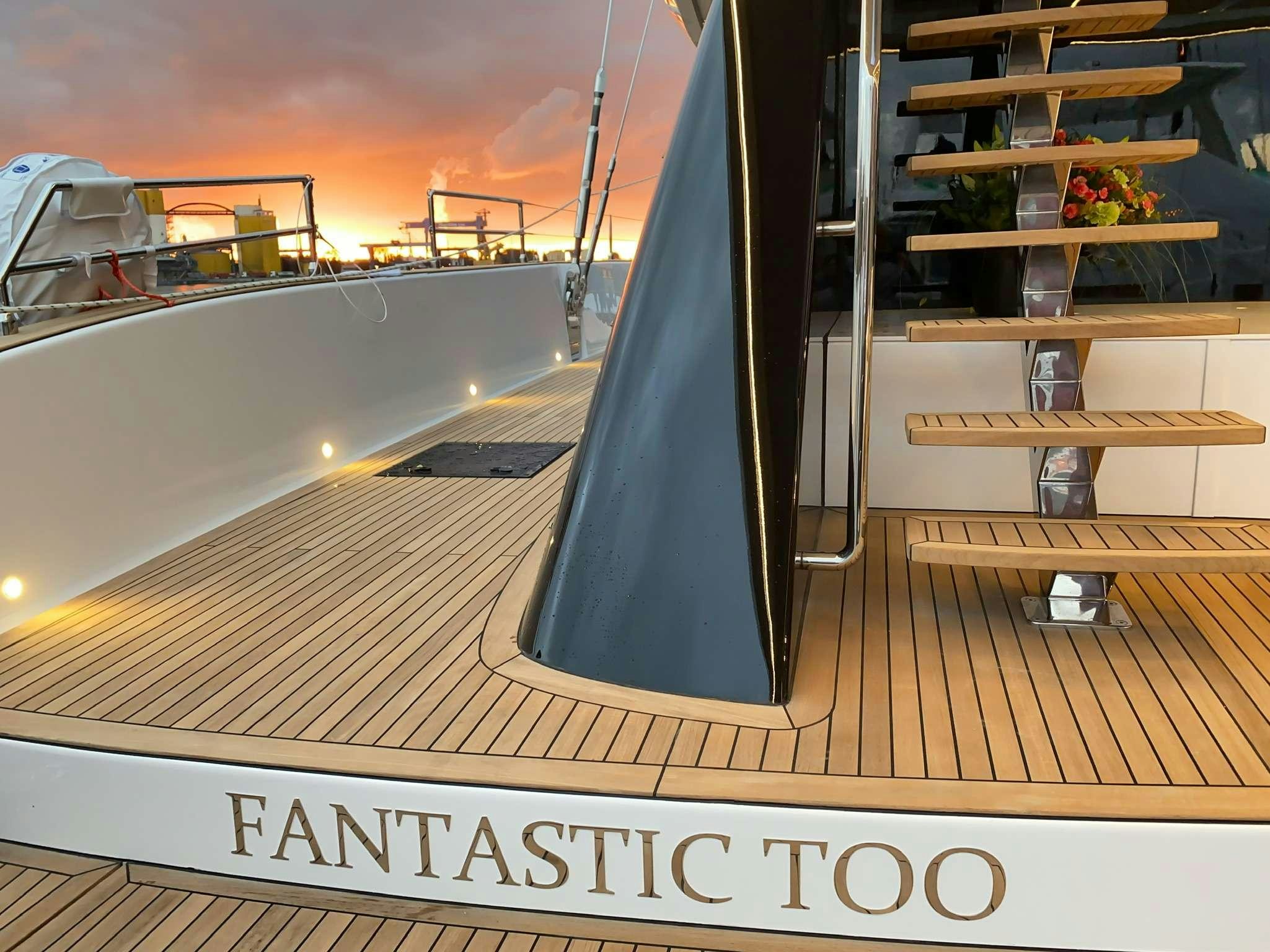 a balcony with a railing and a railing with a railing and a body of water and a pink aboard SUNREEF 80 FANTASTIC TOO Yacht for Charter