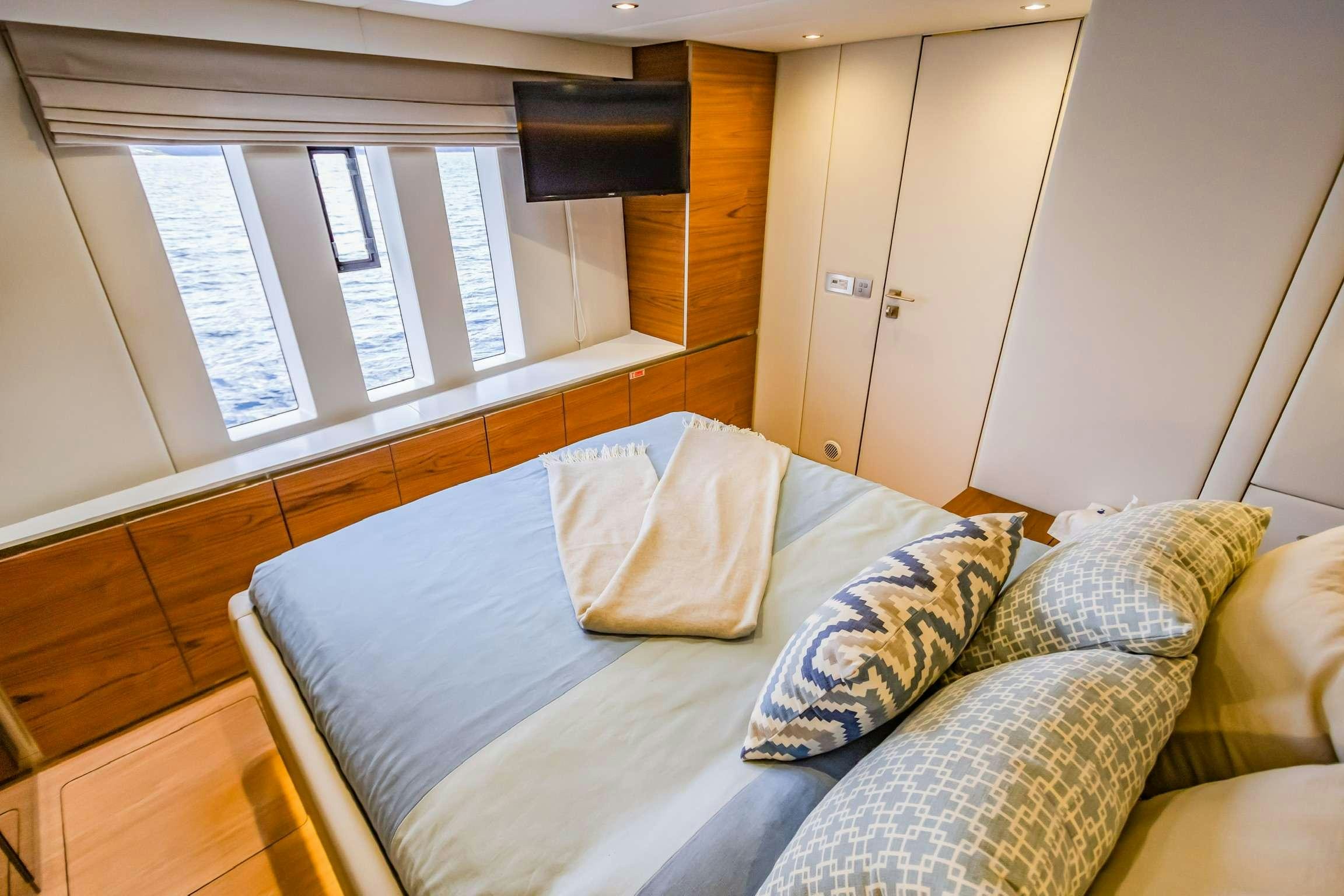 a couch with pillows in a room aboard SUNREEF 80 FANTASTIC TOO Yacht for Charter